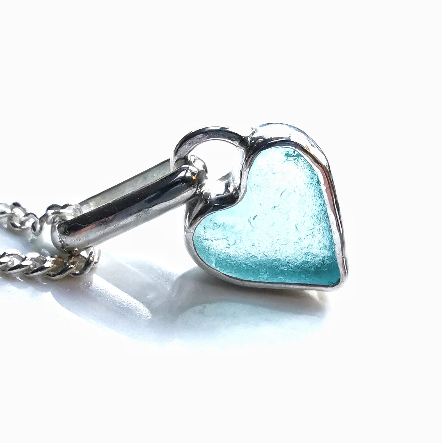Aqua blue UV sea glass heart  & sterling silver pendant.