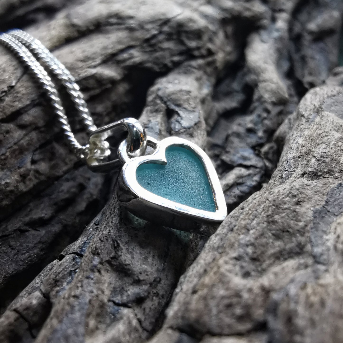 Aqua blue UV sea glass heart  & sterling silver pendant.