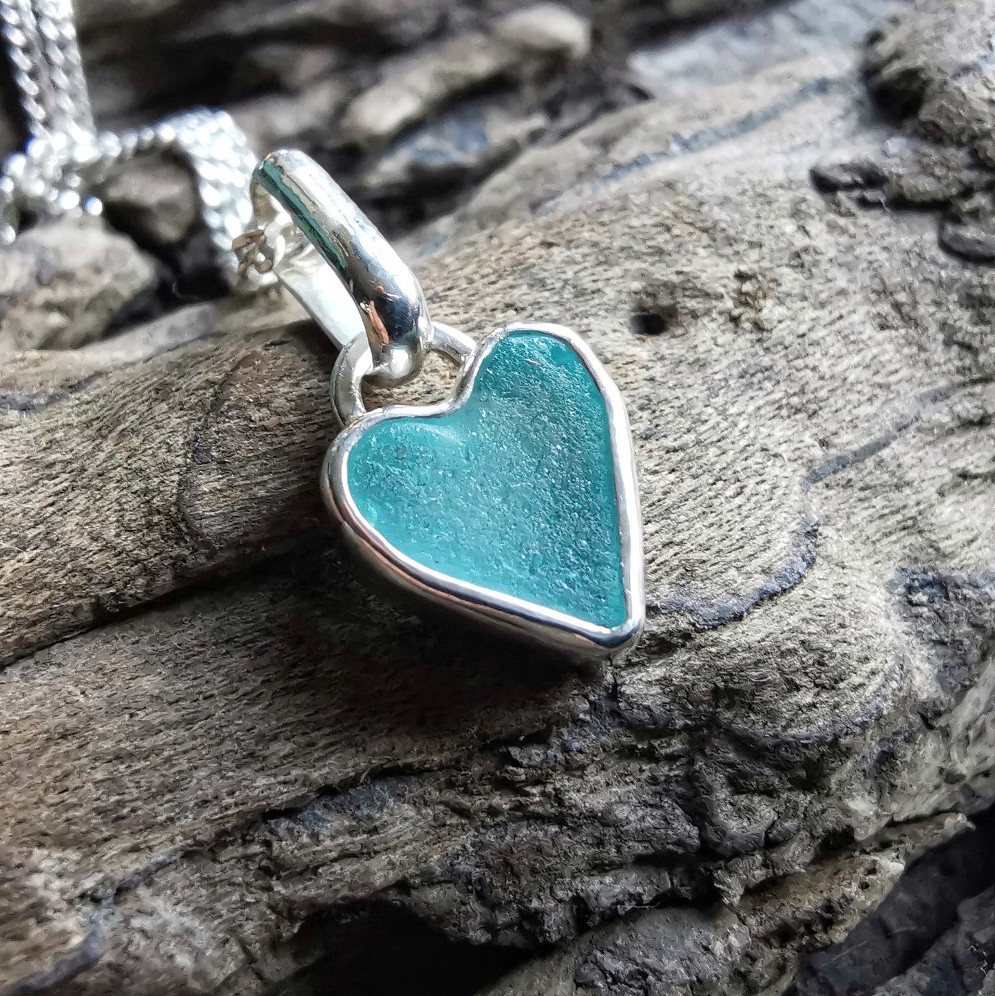 Aqua blue UV sea glass heart  & sterling silver pendant.
