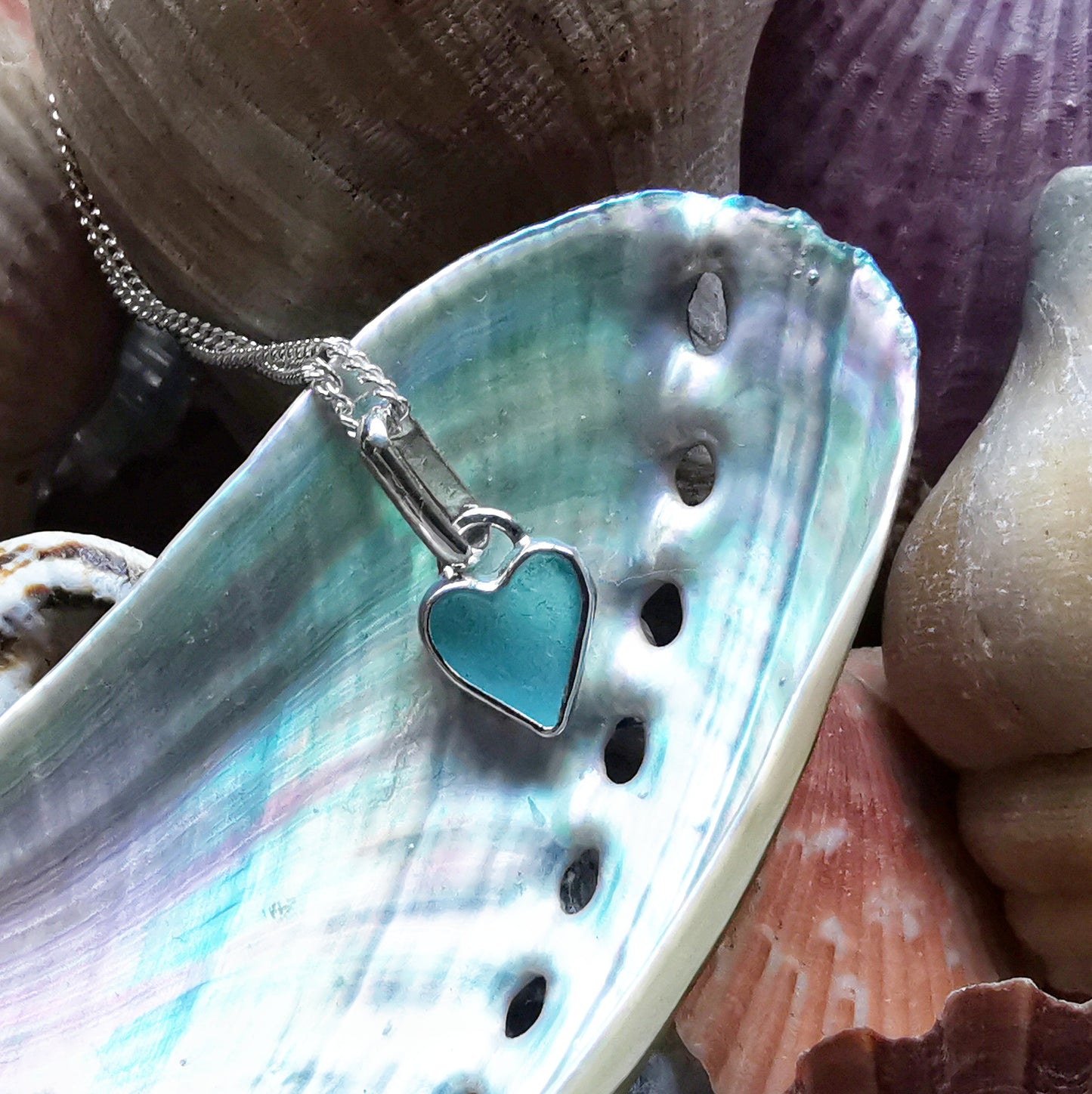 Aqua blue UV sea glass heart  & sterling silver pendant.