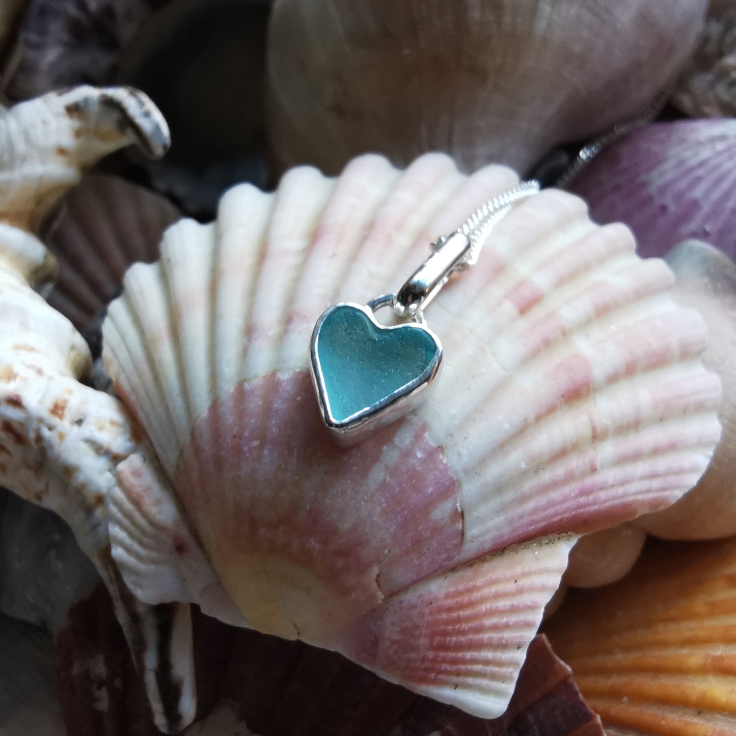 Aqua blue UV sea glass heart  & sterling silver pendant.