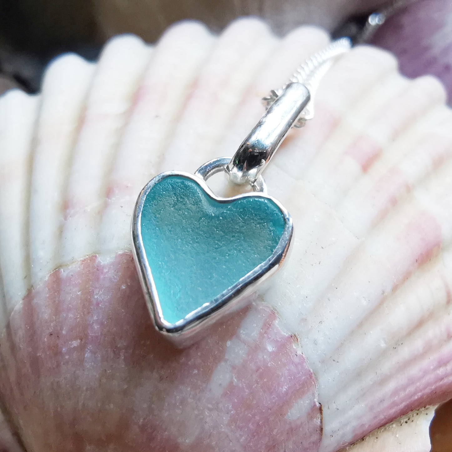 Aqua blue UV sea glass heart  & sterling silver pendant.