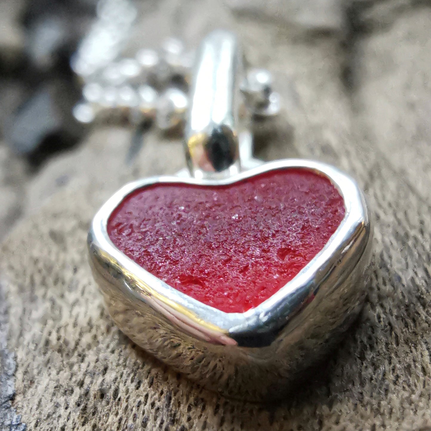 Tiny Scottish UV red sea glass heart & sterling silver pendant.