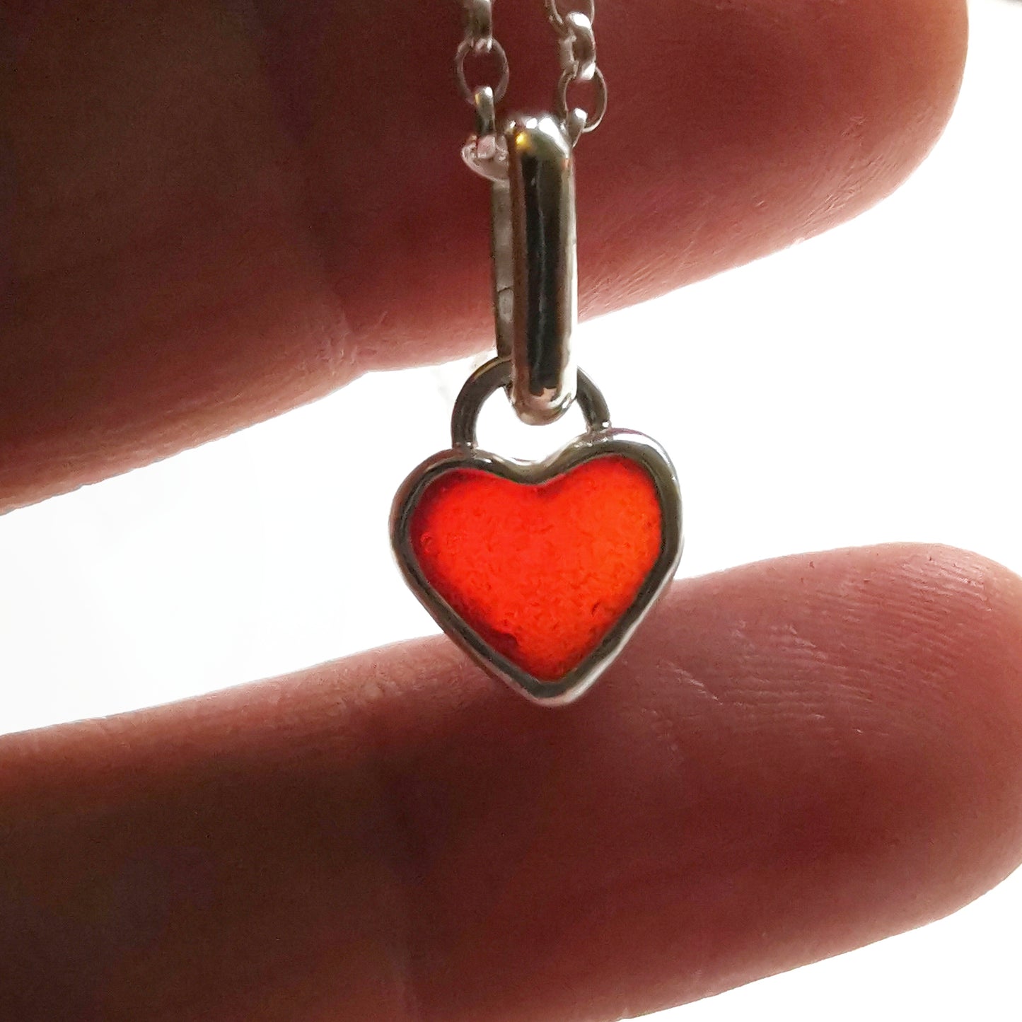 Tiny Scottish UV red sea glass heart & sterling silver pendant.