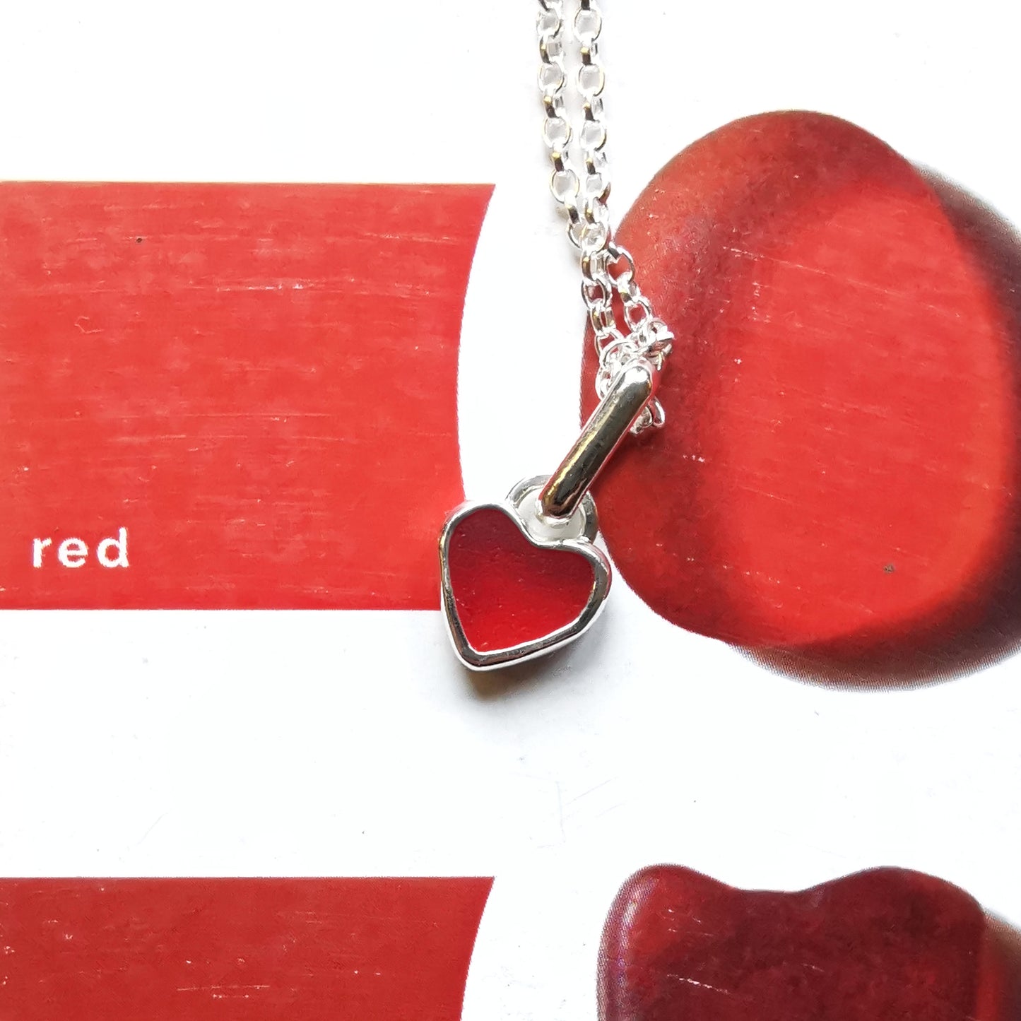Tiny Scottish UV red sea glass heart & sterling silver pendant.