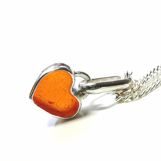 Tiny Scottish orange UV sea glass heart & sterling silver pendant.