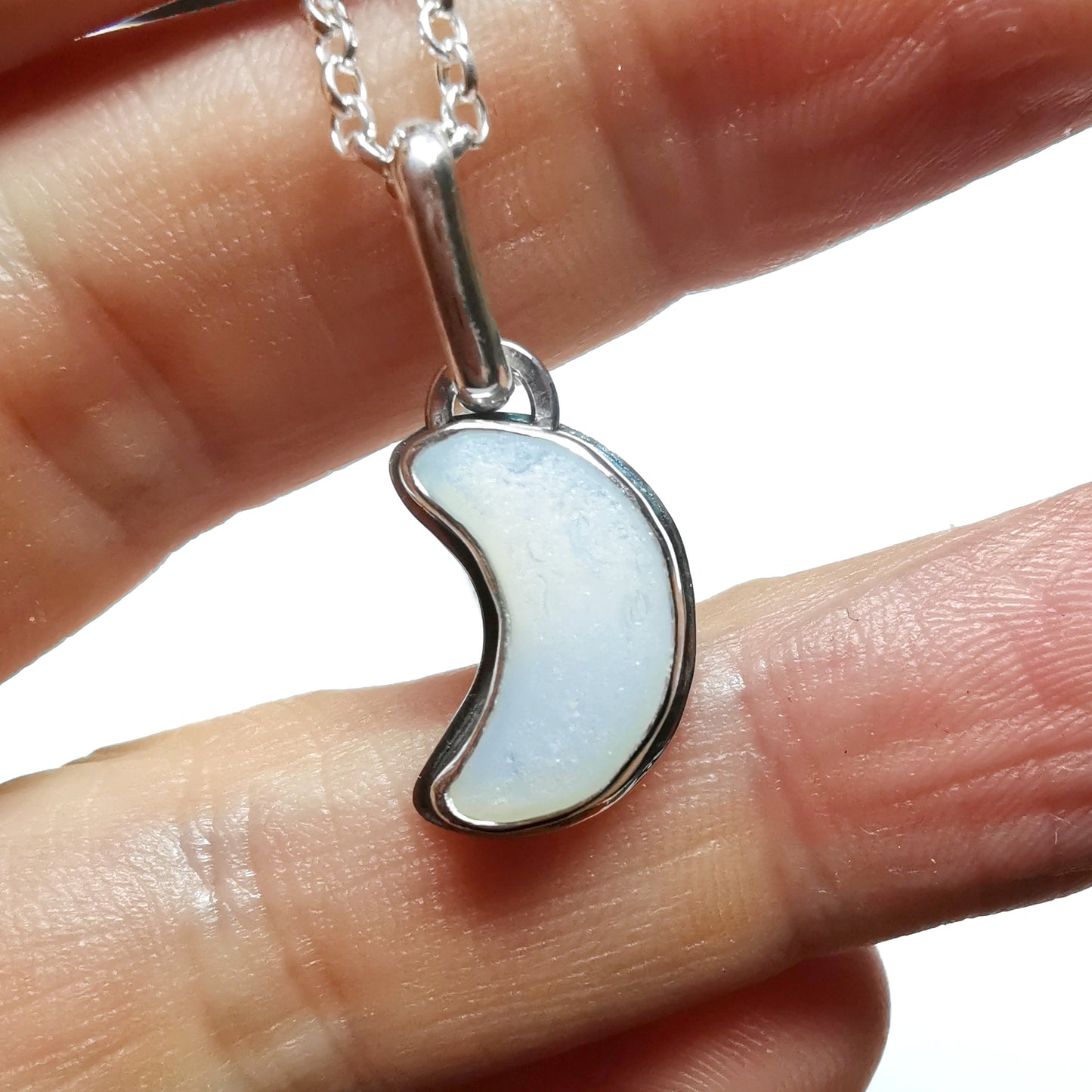 Opalescent crescent moon sea glass & sterling silver pendant.