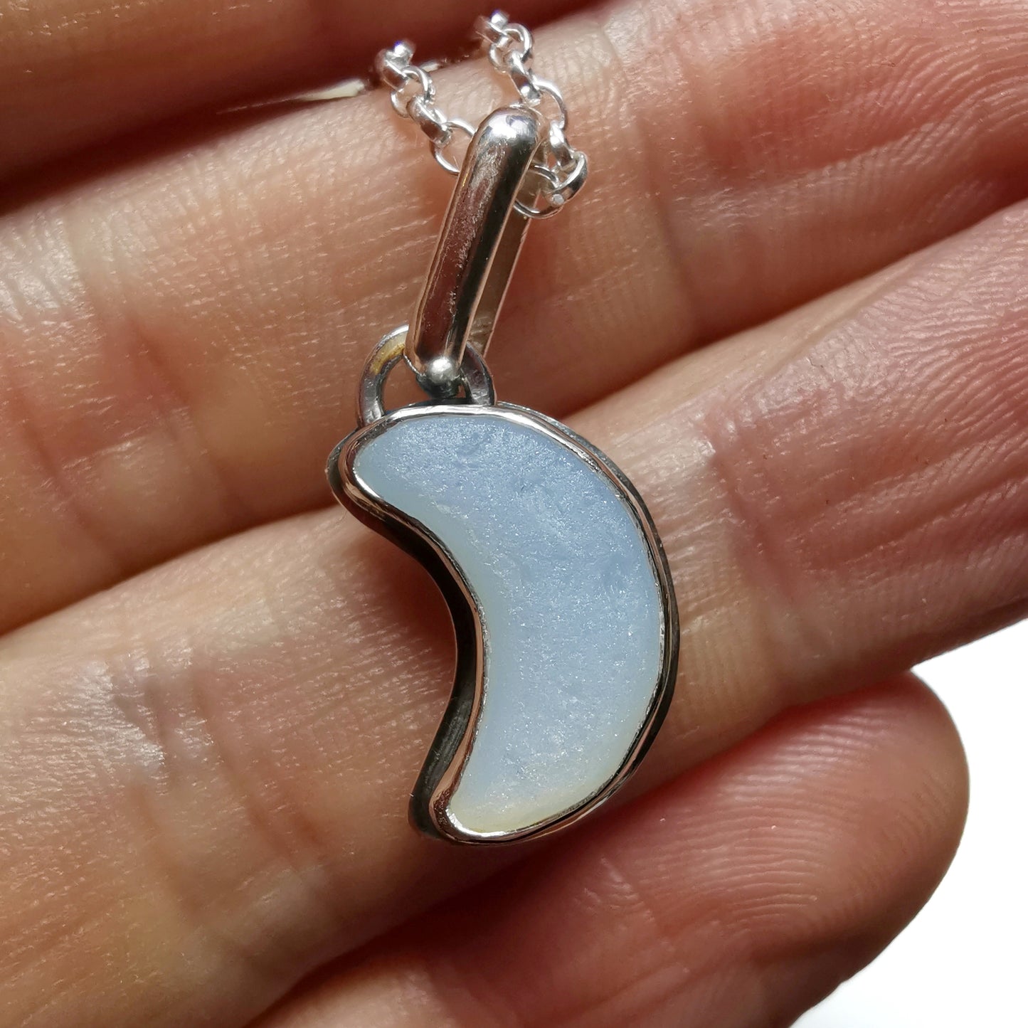 Opalescent crescent moon sea glass & sterling silver pendant.