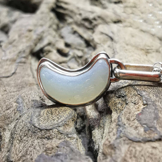Opalescent crescent moon sea glass & sterling silver pendant.