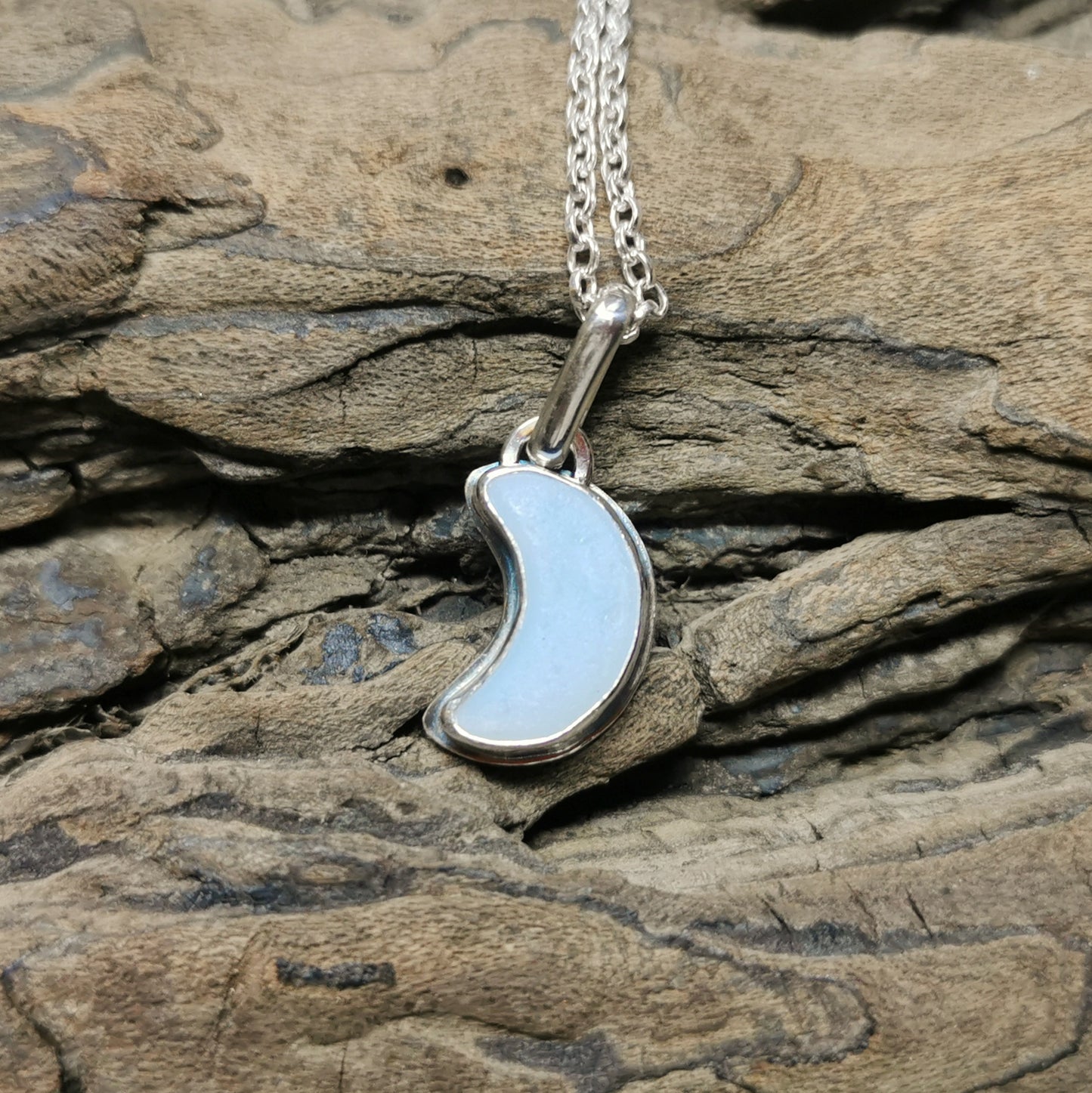 Opalescent crescent moon sea glass & sterling silver pendant.