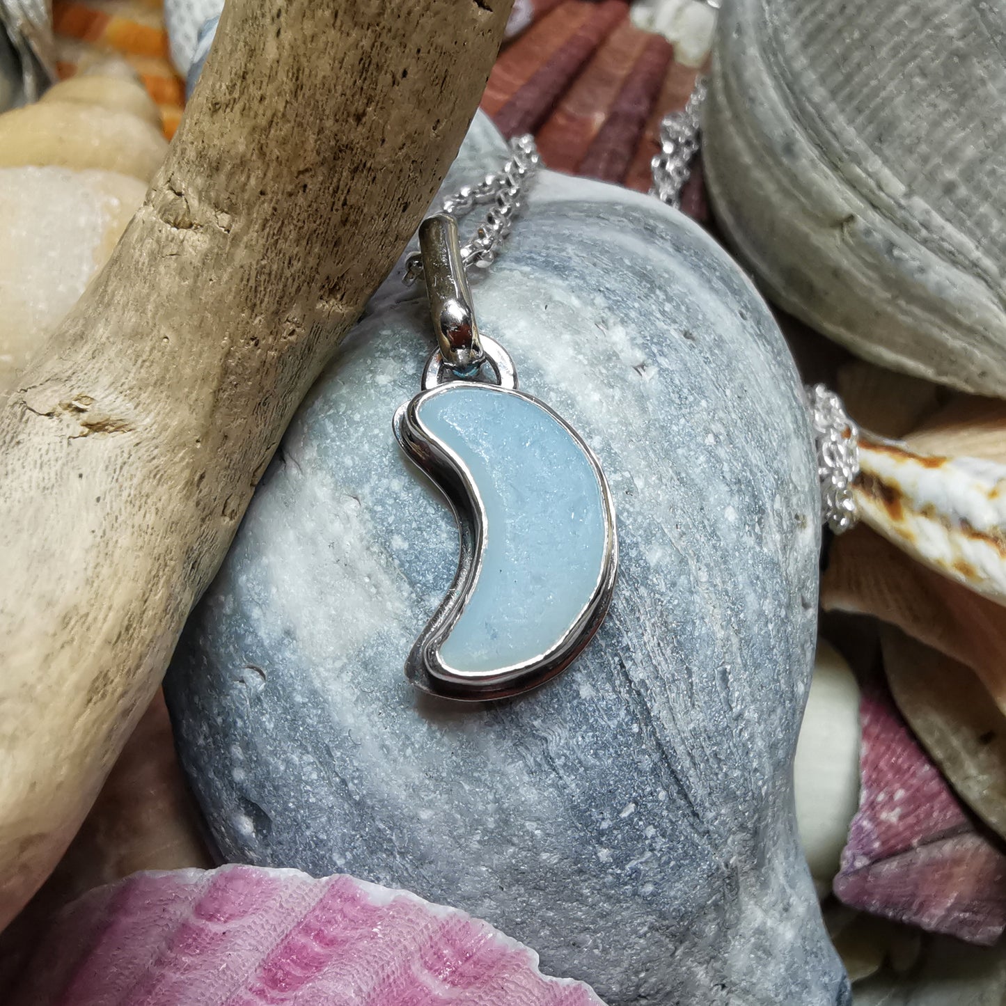 Opalescent crescent moon sea glass & sterling silver pendant.