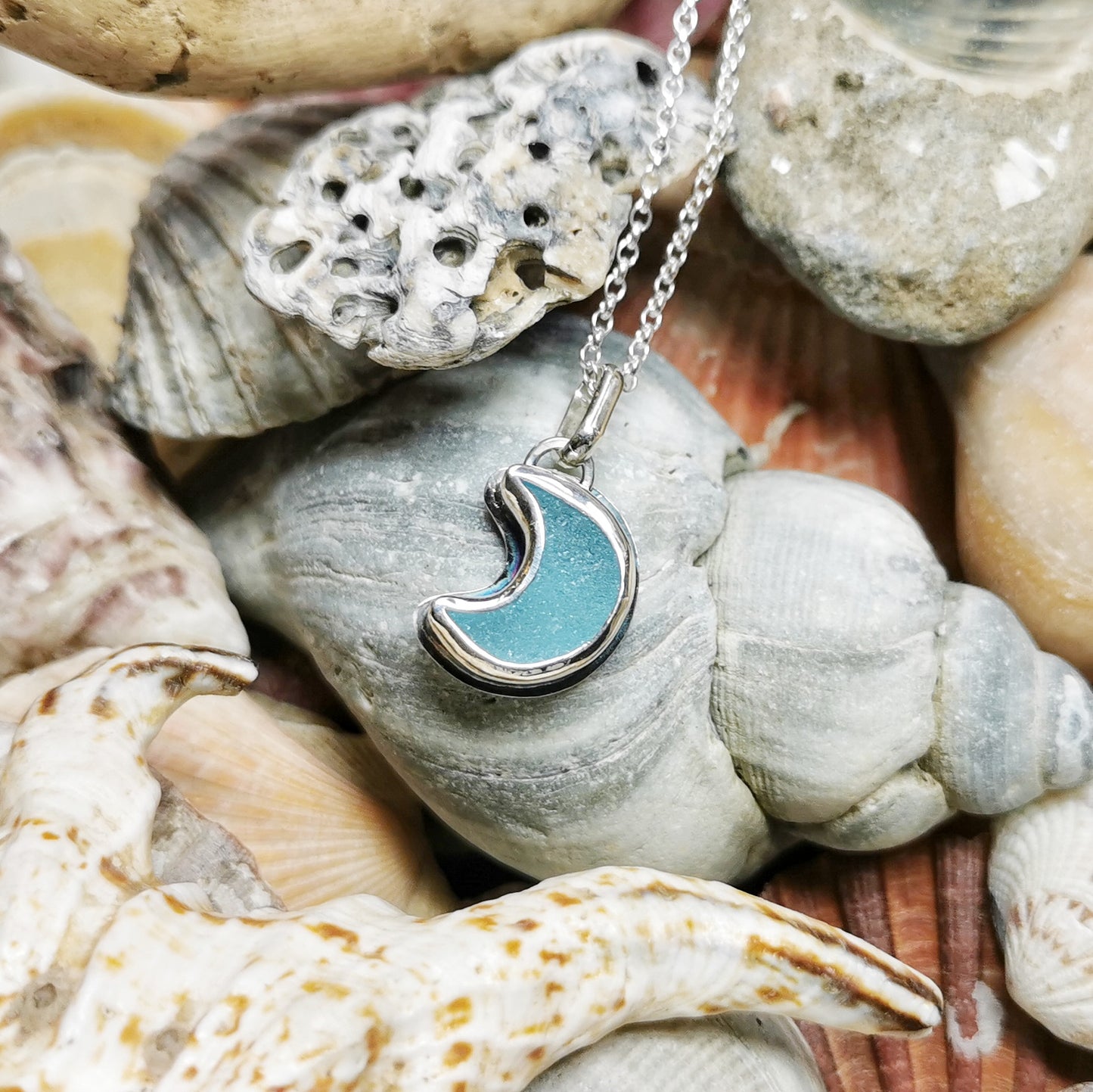 Aqua crescent moon sea glass & sterling silver pendant.