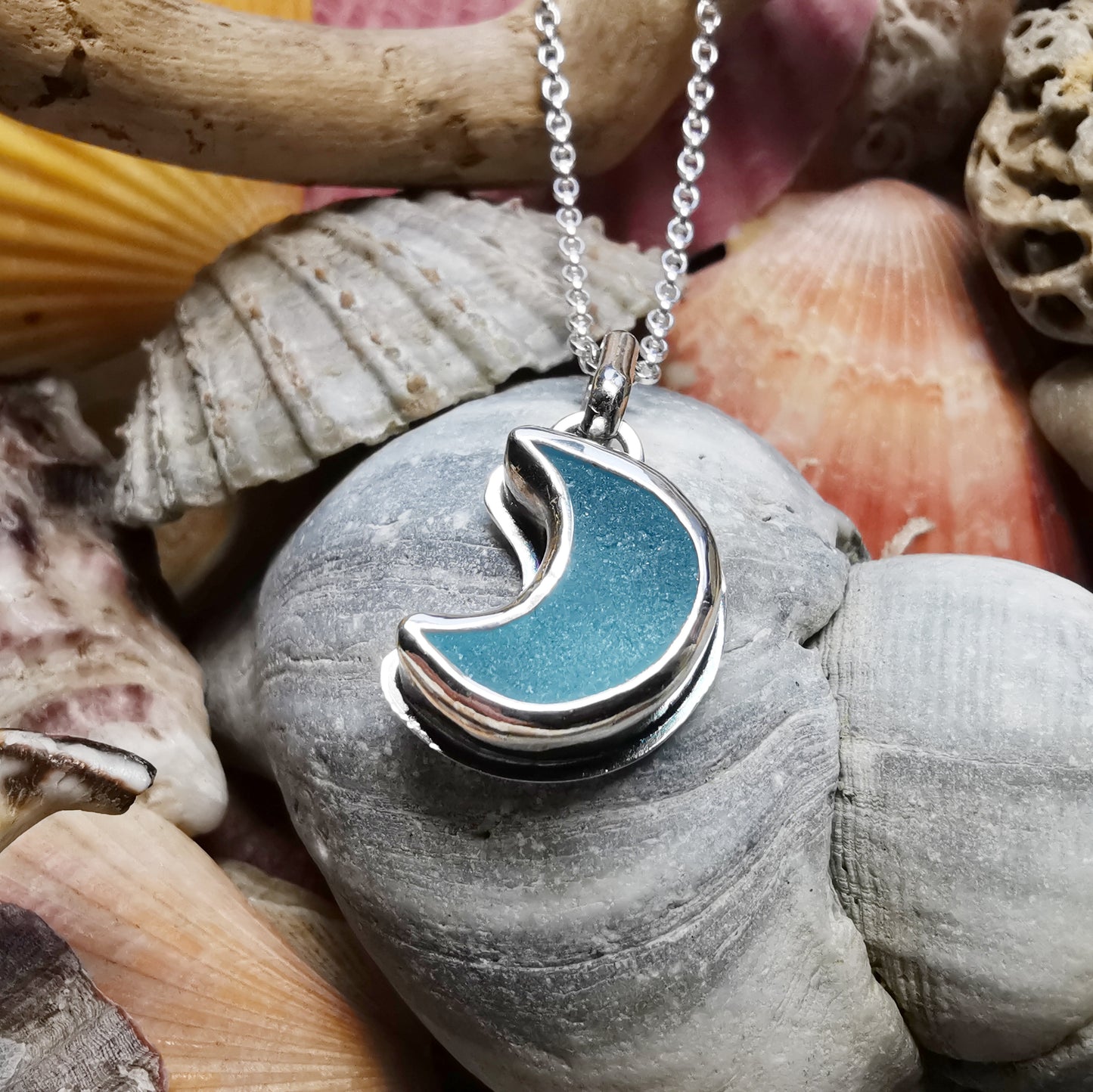 Aqua crescent moon sea glass & sterling silver pendant.