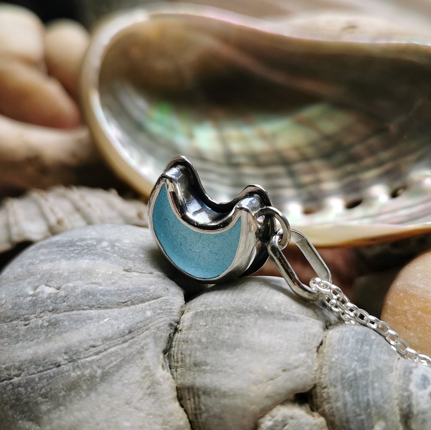 Aqua crescent moon sea glass & sterling silver pendant.
