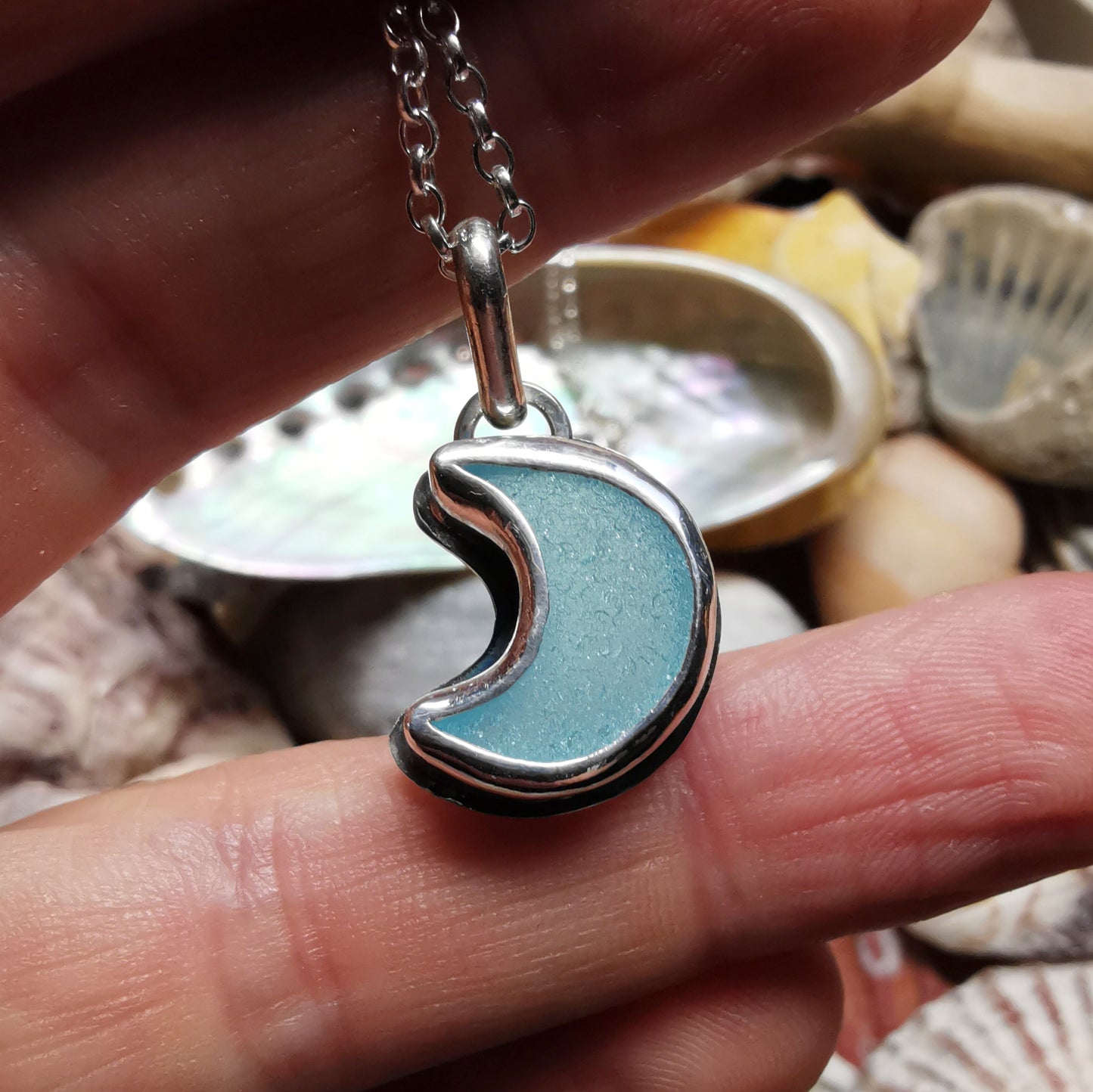 Aqua crescent moon sea glass & sterling silver pendant.