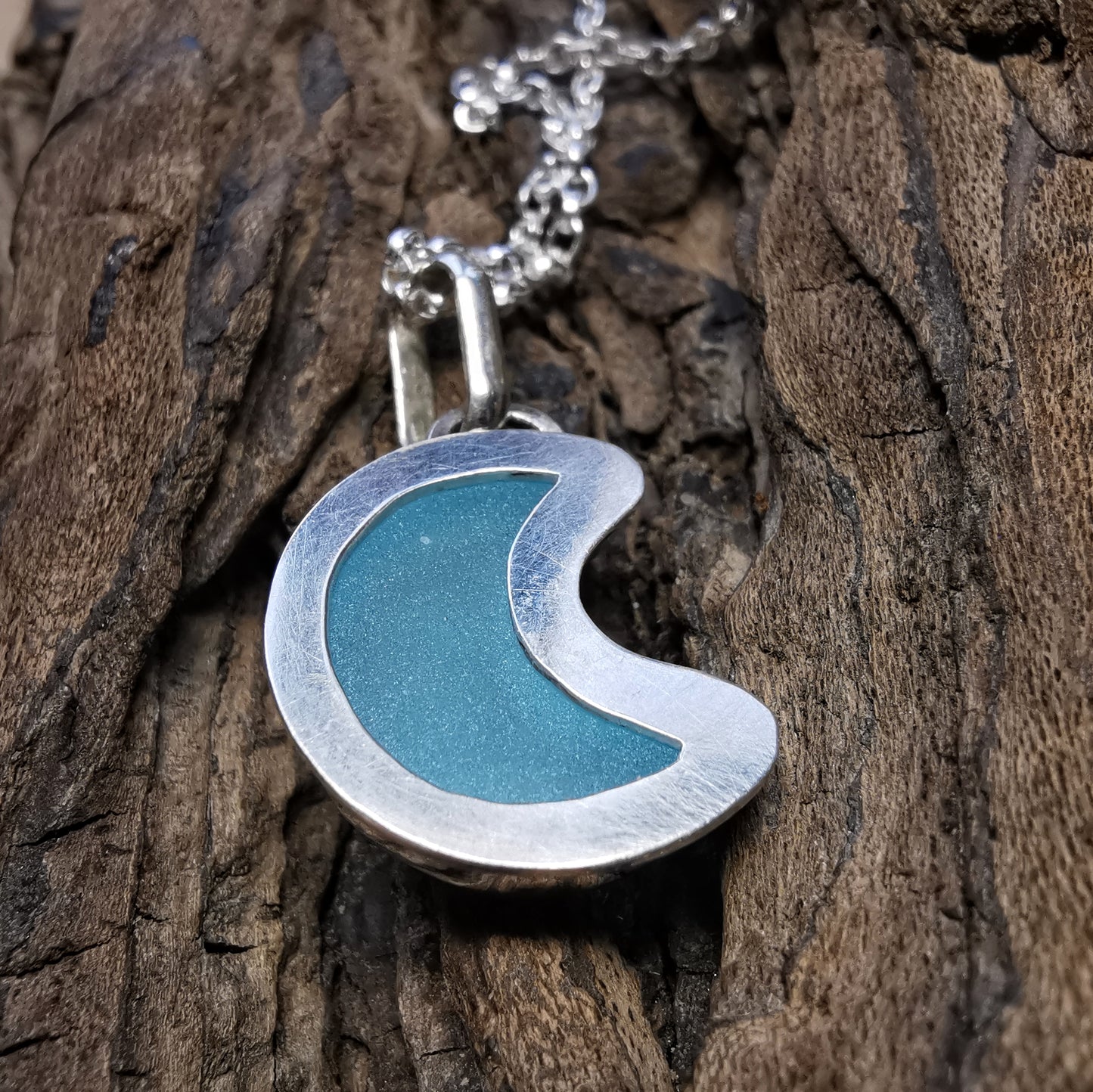 Aqua crescent moon sea glass & sterling silver pendant.