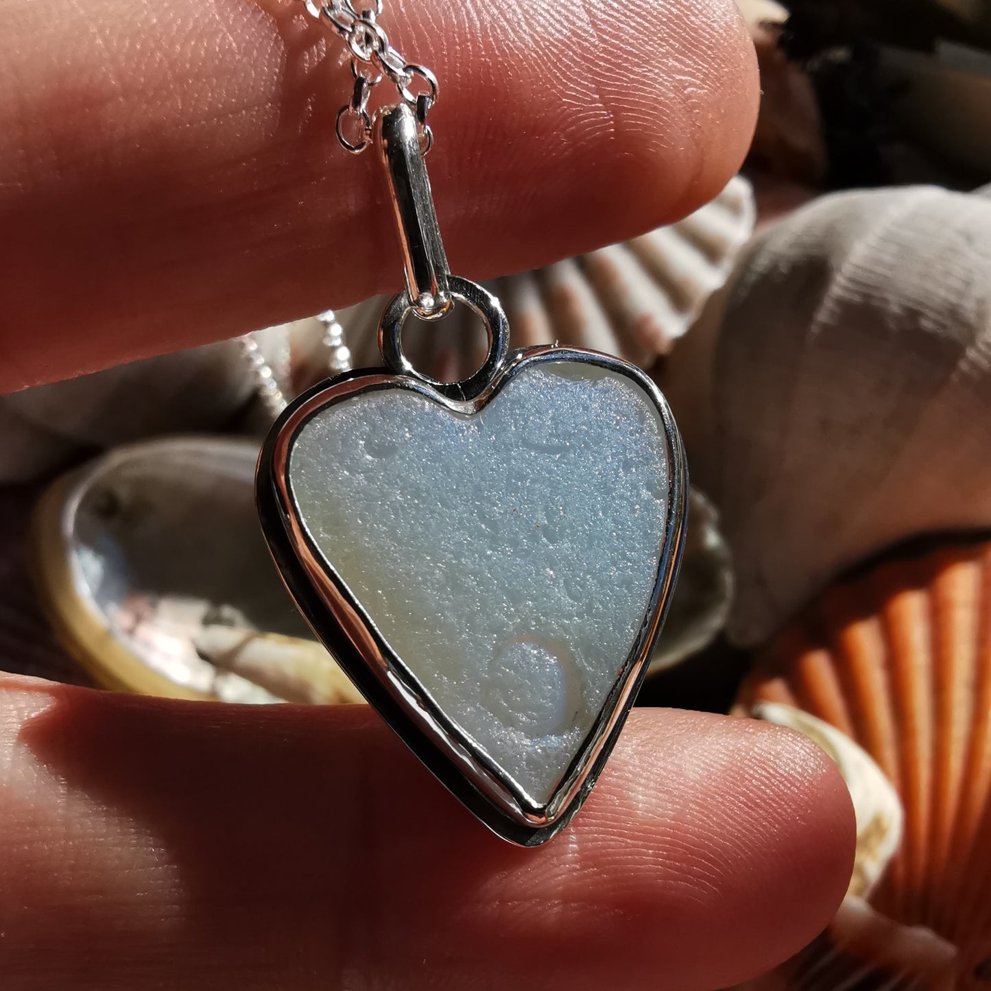 Reserved. Opalescent sea glass heart & sterling silver pendant.
