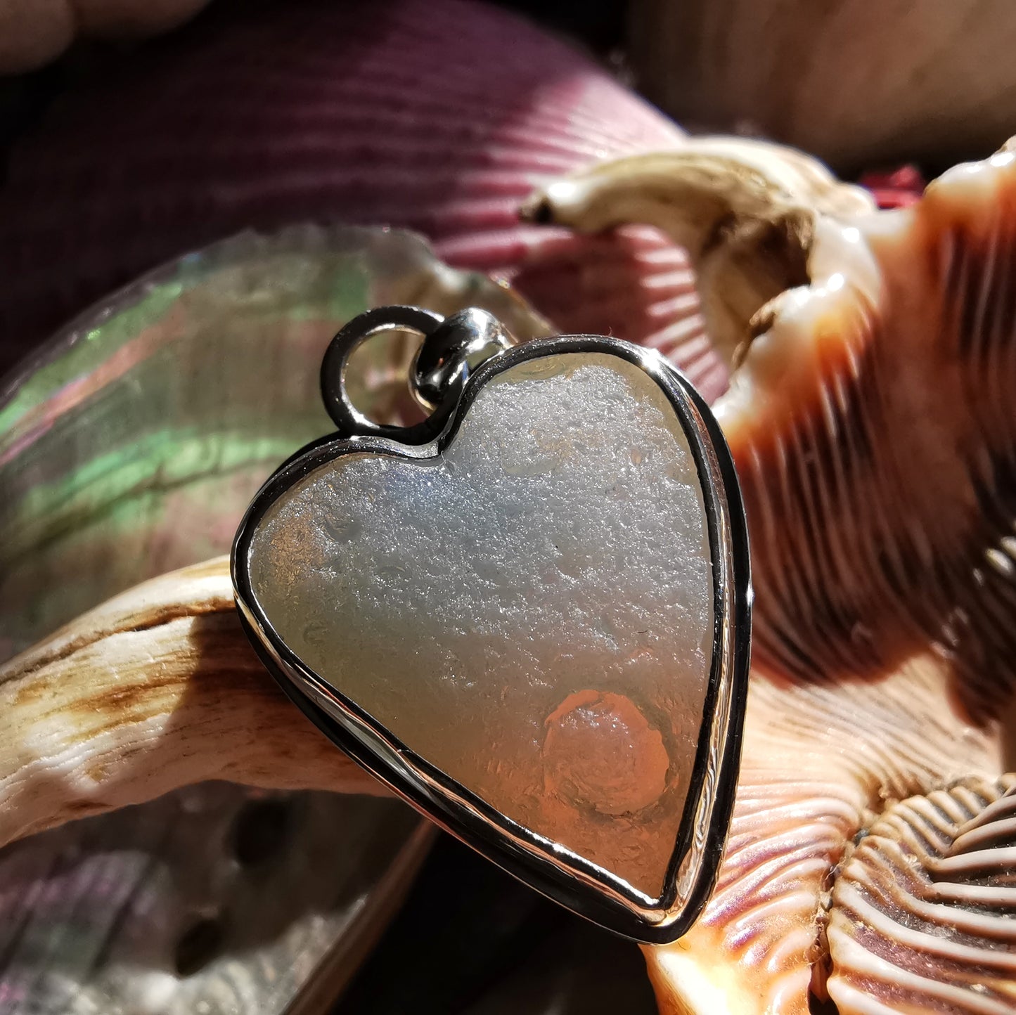 Reserved. Opalescent sea glass heart & sterling silver pendant.