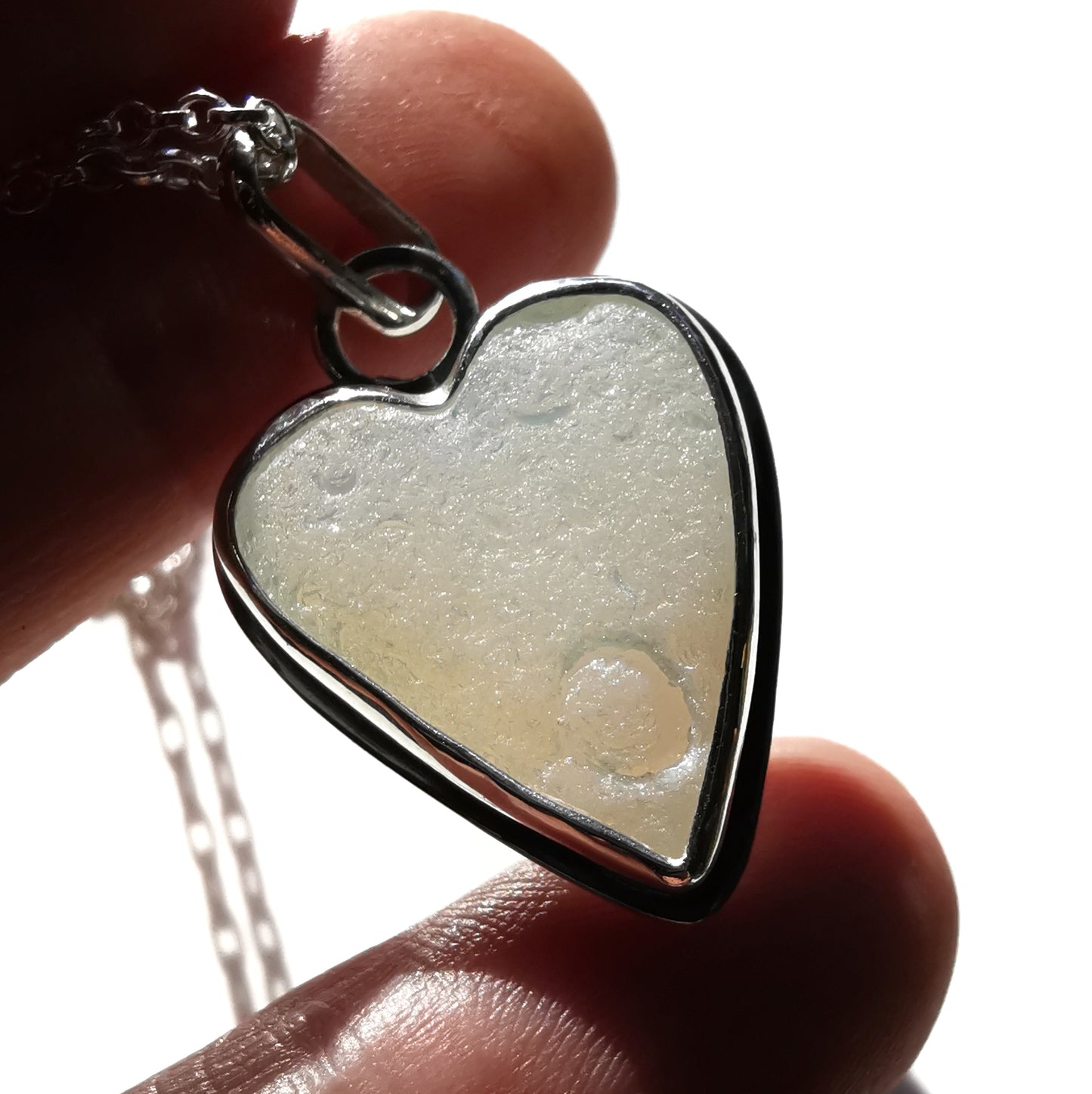 Reserved. Opalescent sea glass heart & sterling silver pendant.