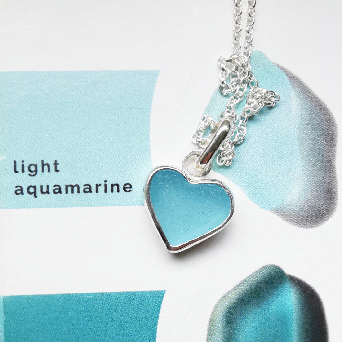 Light aquamarine blue sea glass heart & sterling silver pendant.