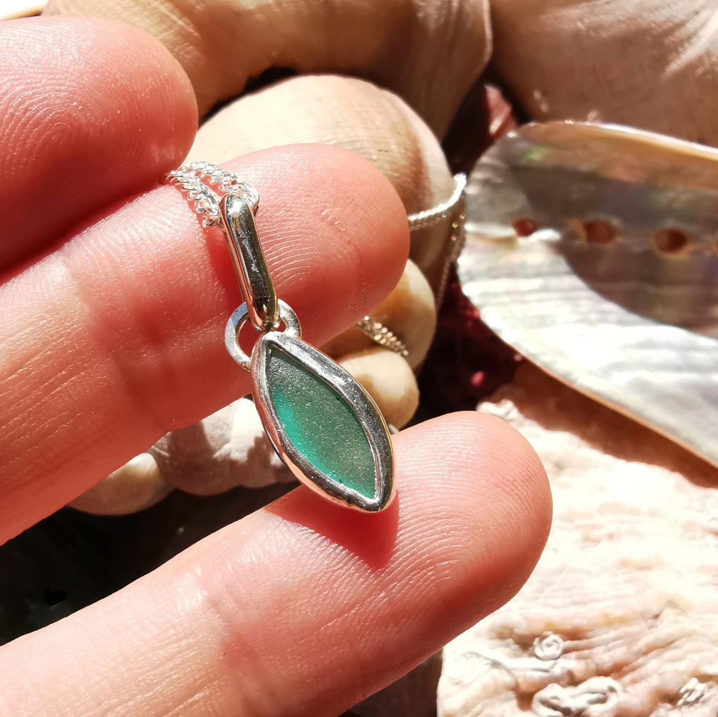 Tiny Scottish teal sea glass & sterling silver pendant.