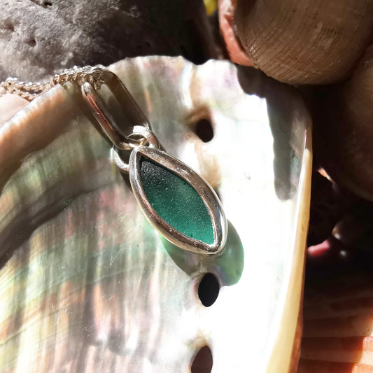 Tiny Scottish teal sea glass & sterling silver pendant.