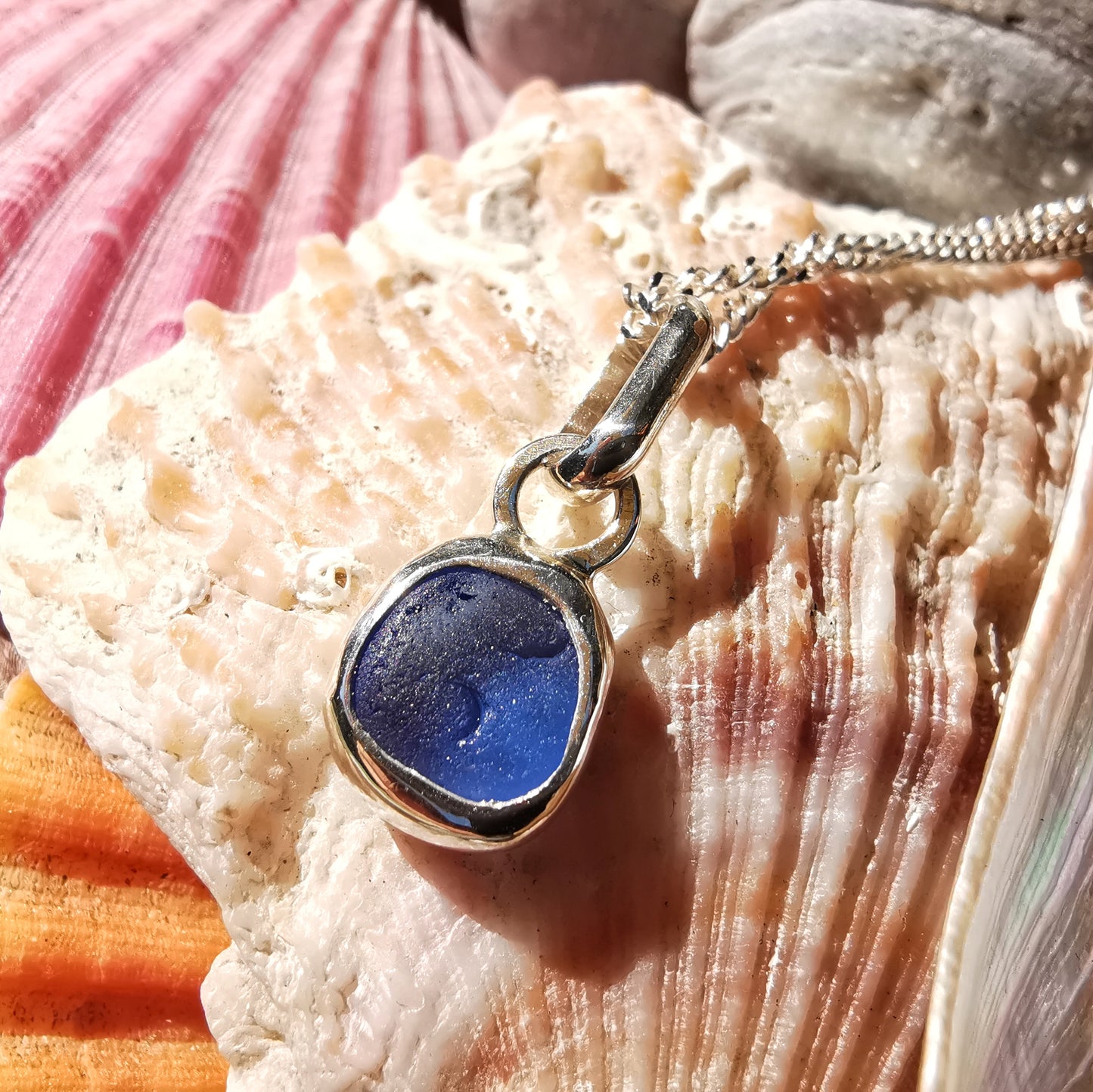 Tiny Scottish cornflower blue sea glass & sterling silver pendant.