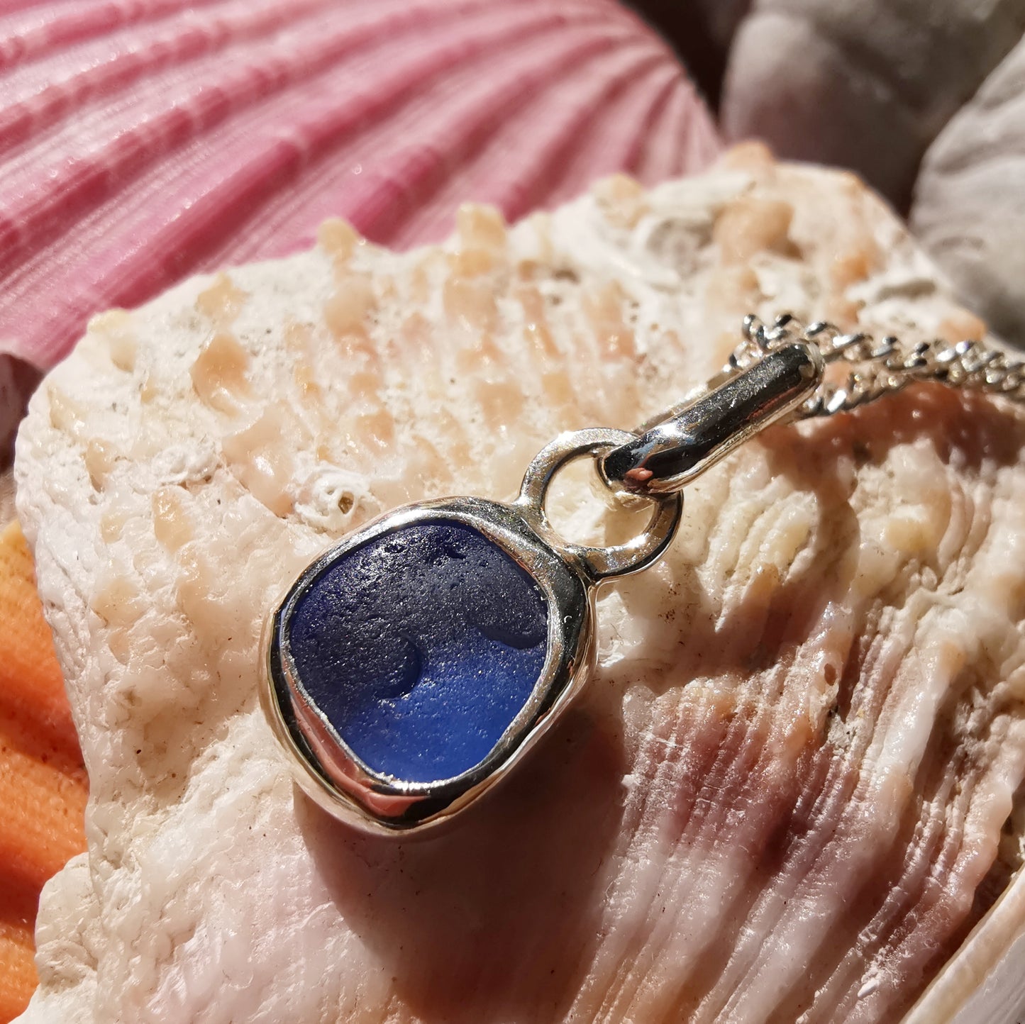 Tiny Scottish cornflower blue sea glass & sterling silver pendant.