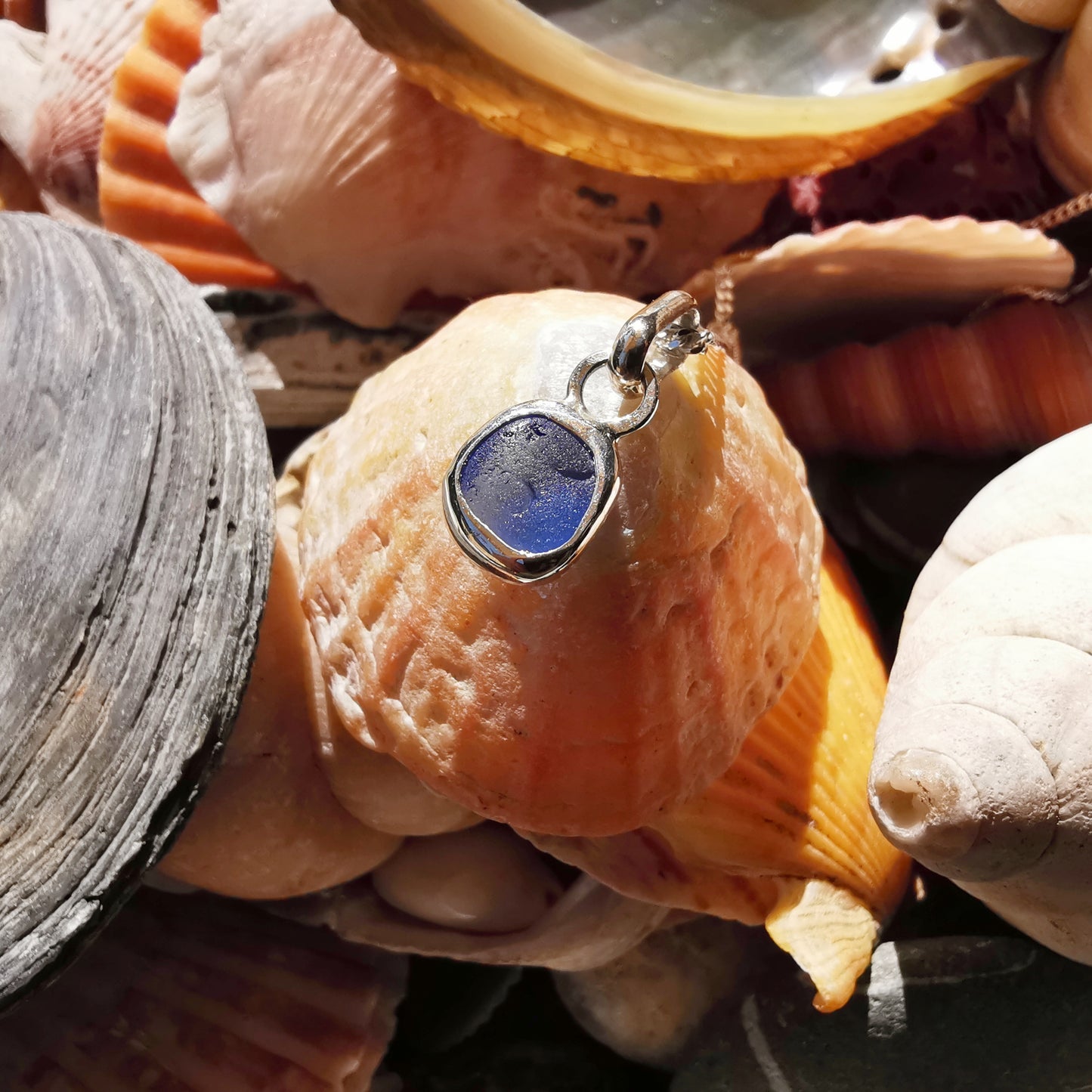 Tiny Scottish cornflower blue sea glass & sterling silver pendant.