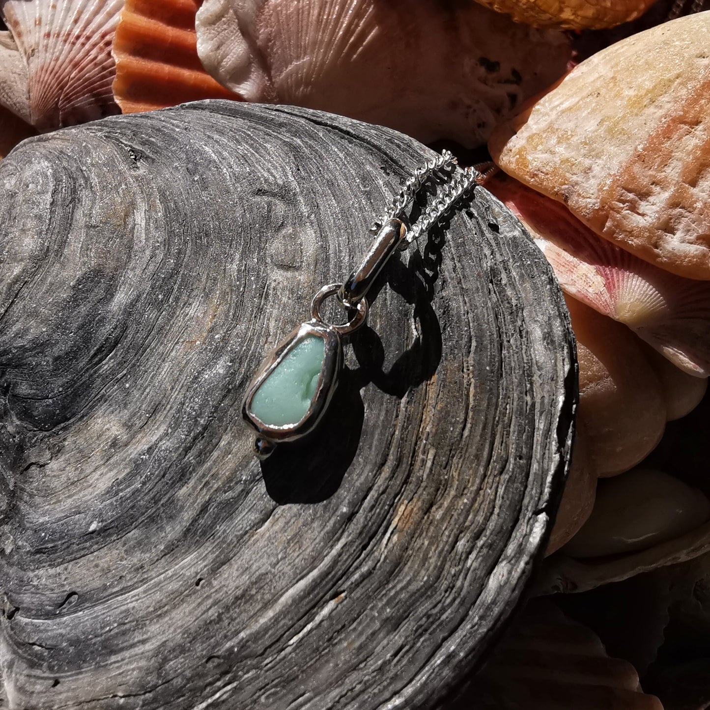 Tiny Scottish UV milk sea glass & sterling silver pendant.
