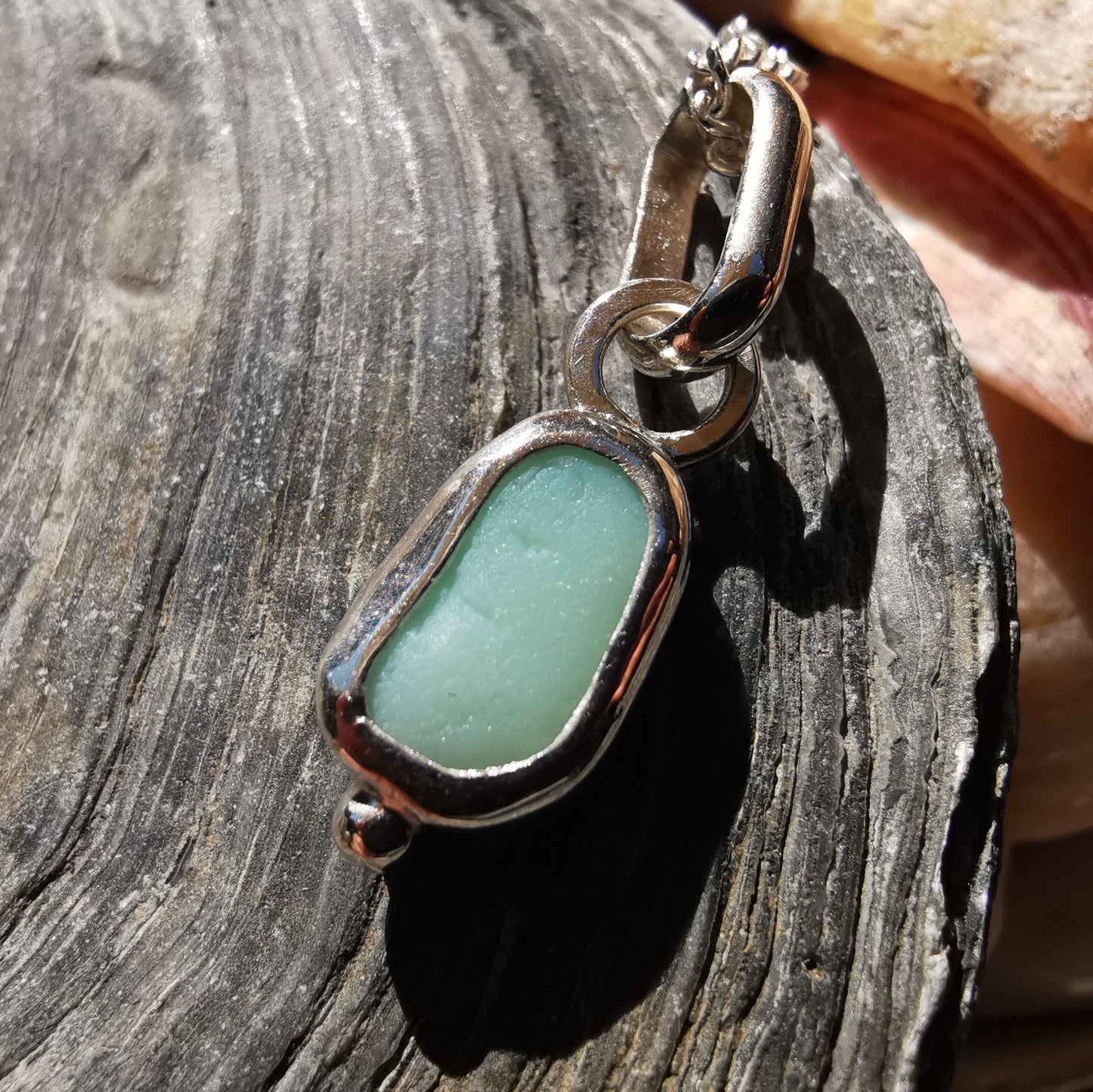 Tiny Scottish UV milk sea glass & sterling silver pendant.