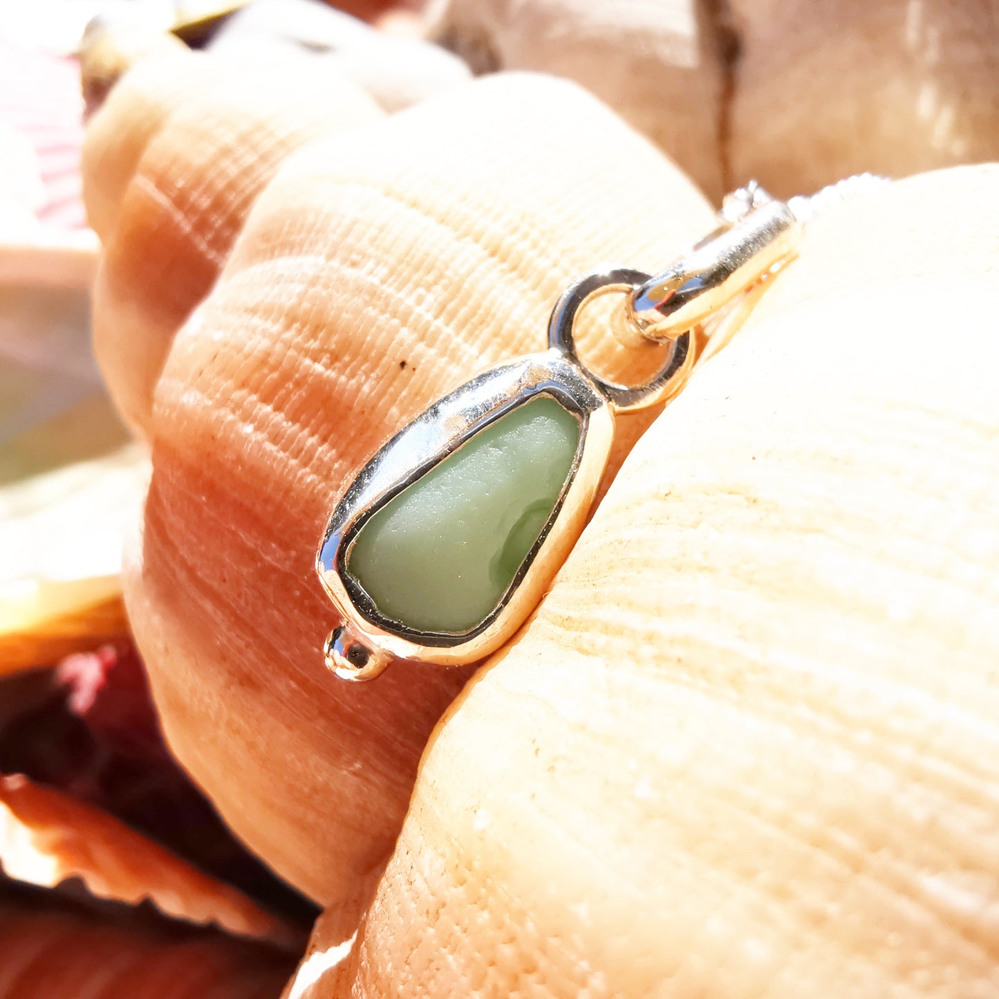 Tiny Scottish UV milk sea glass & sterling silver pendant.
