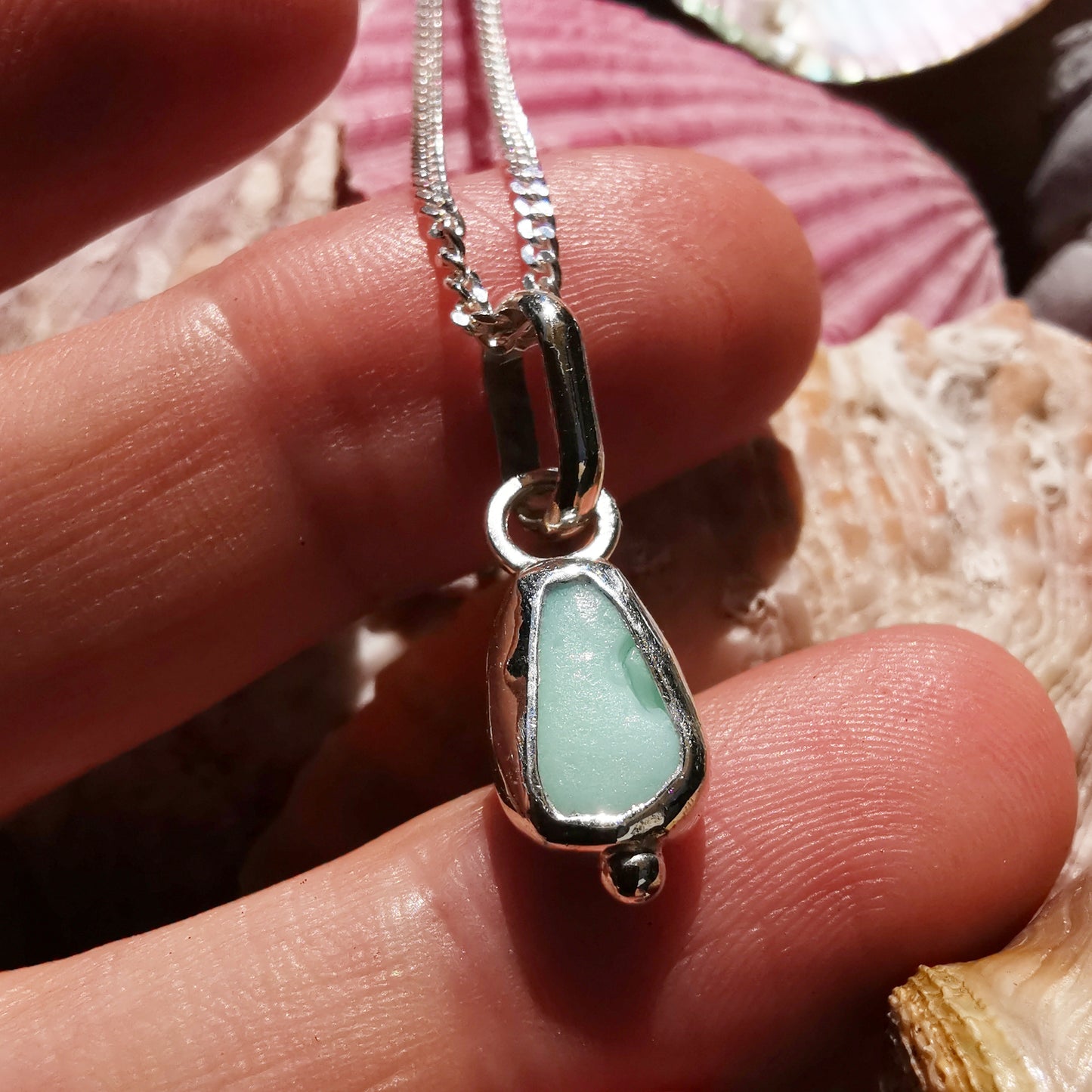 Tiny Scottish UV milk sea glass & sterling silver pendant.