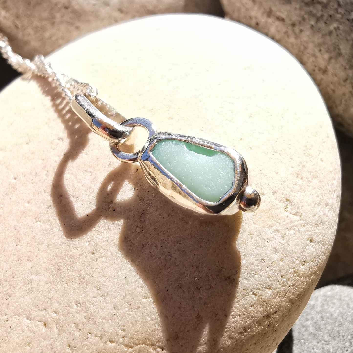 Tiny Scottish UV milk sea glass & sterling silver pendant.