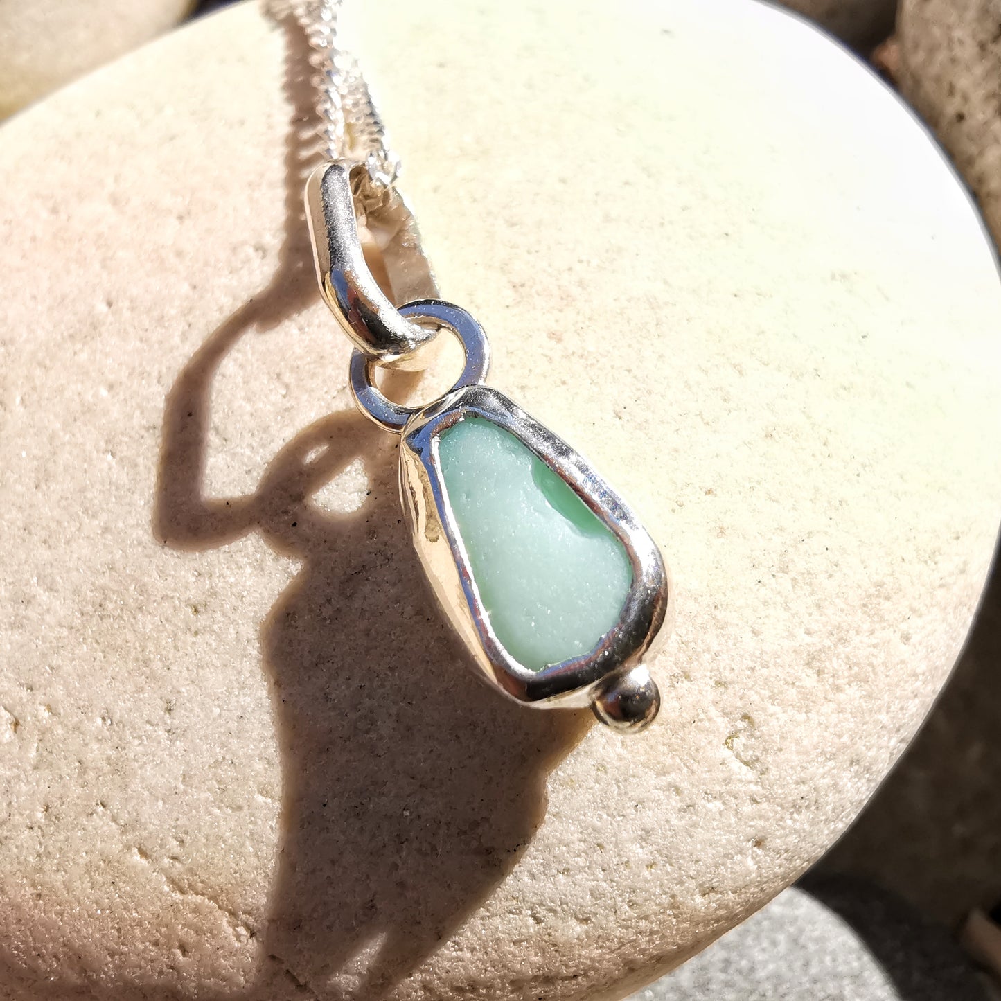 Tiny Scottish UV milk sea glass & sterling silver pendant.