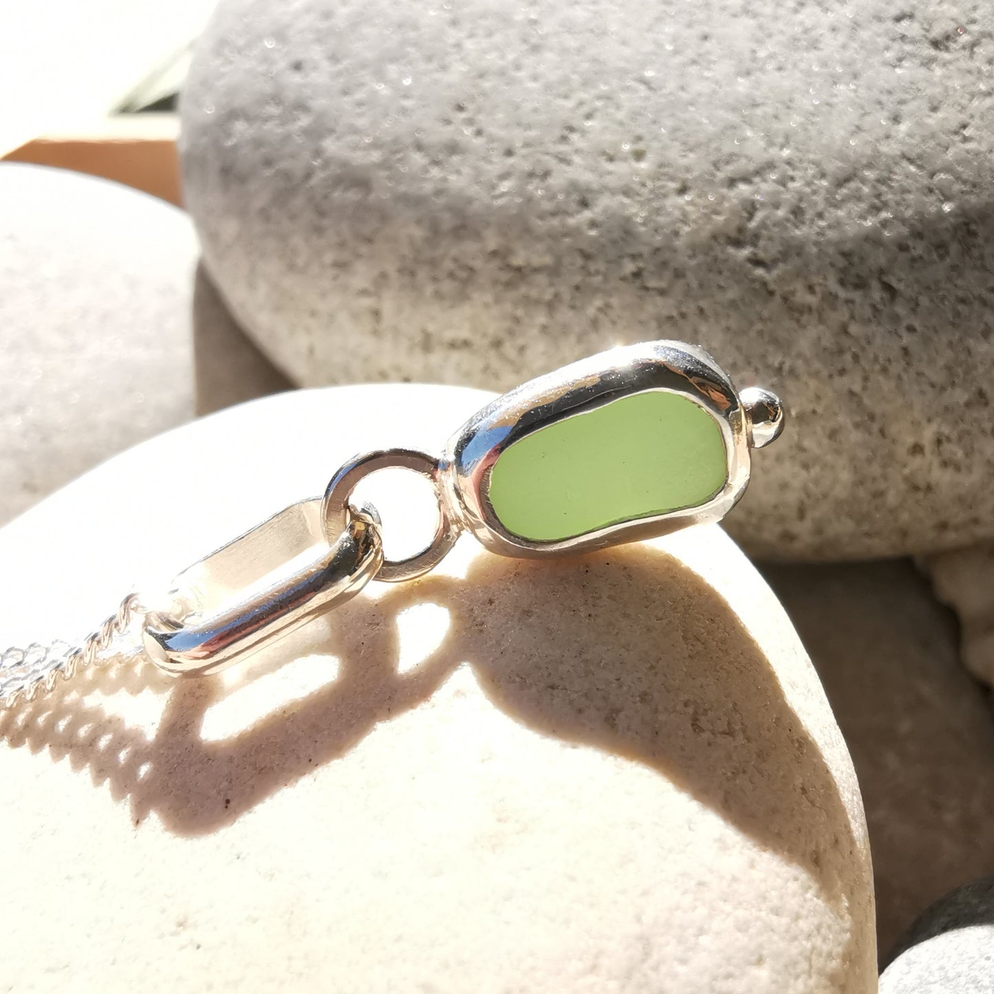 Tiny Scottish UV milk sea glass & sterling silver pendant.