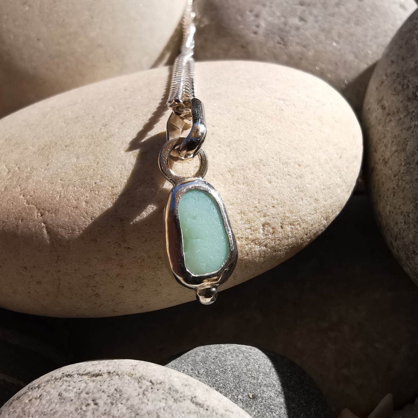Tiny Scottish UV milk sea glass & sterling silver pendant.