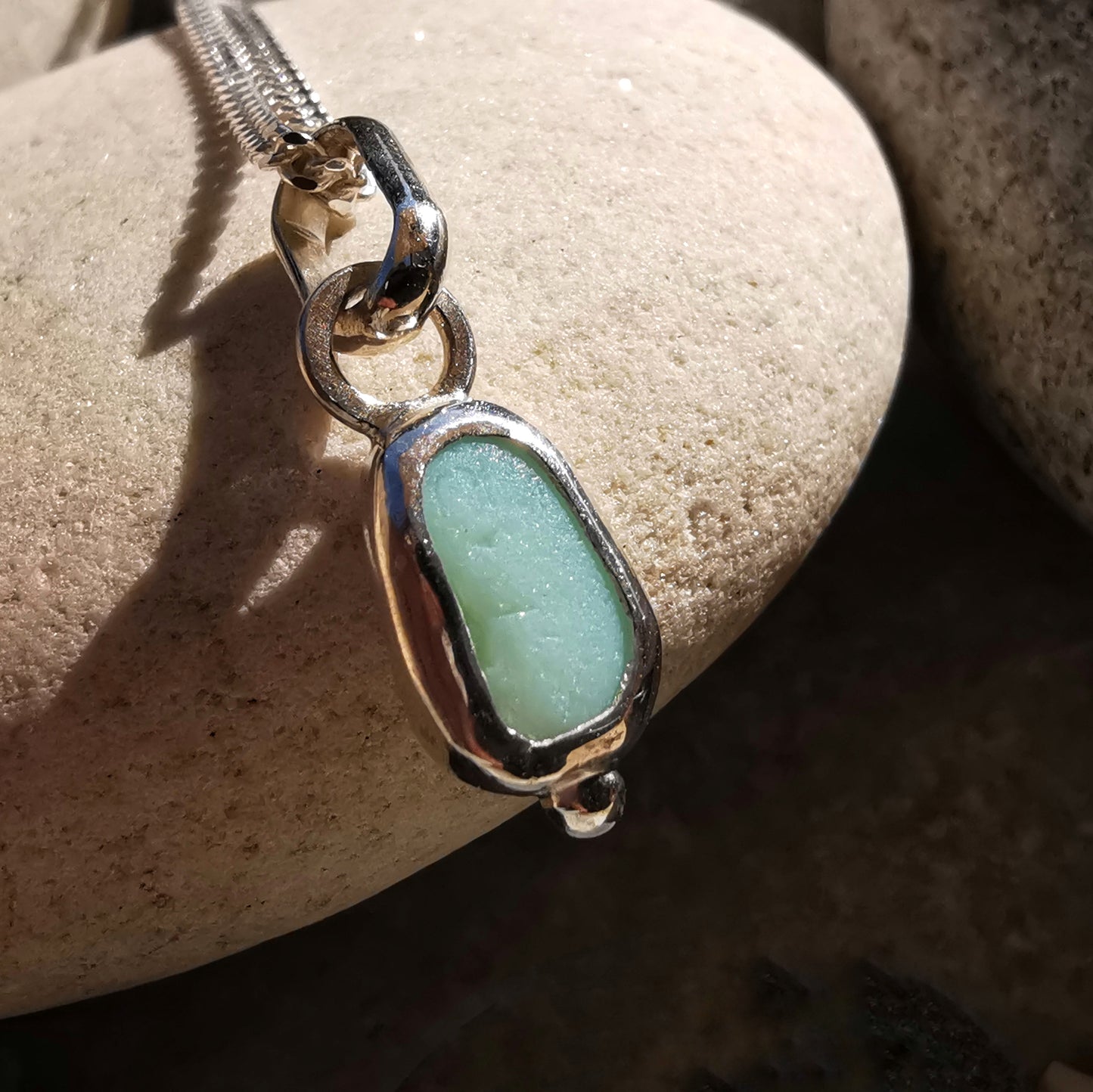 Tiny Scottish UV milk sea glass & sterling silver pendant.