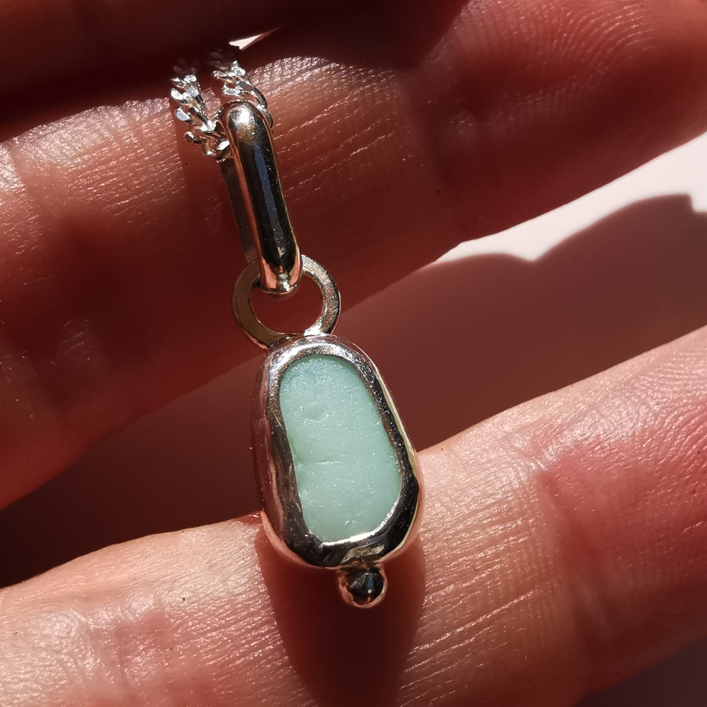 Tiny Scottish UV milk sea glass & sterling silver pendant.