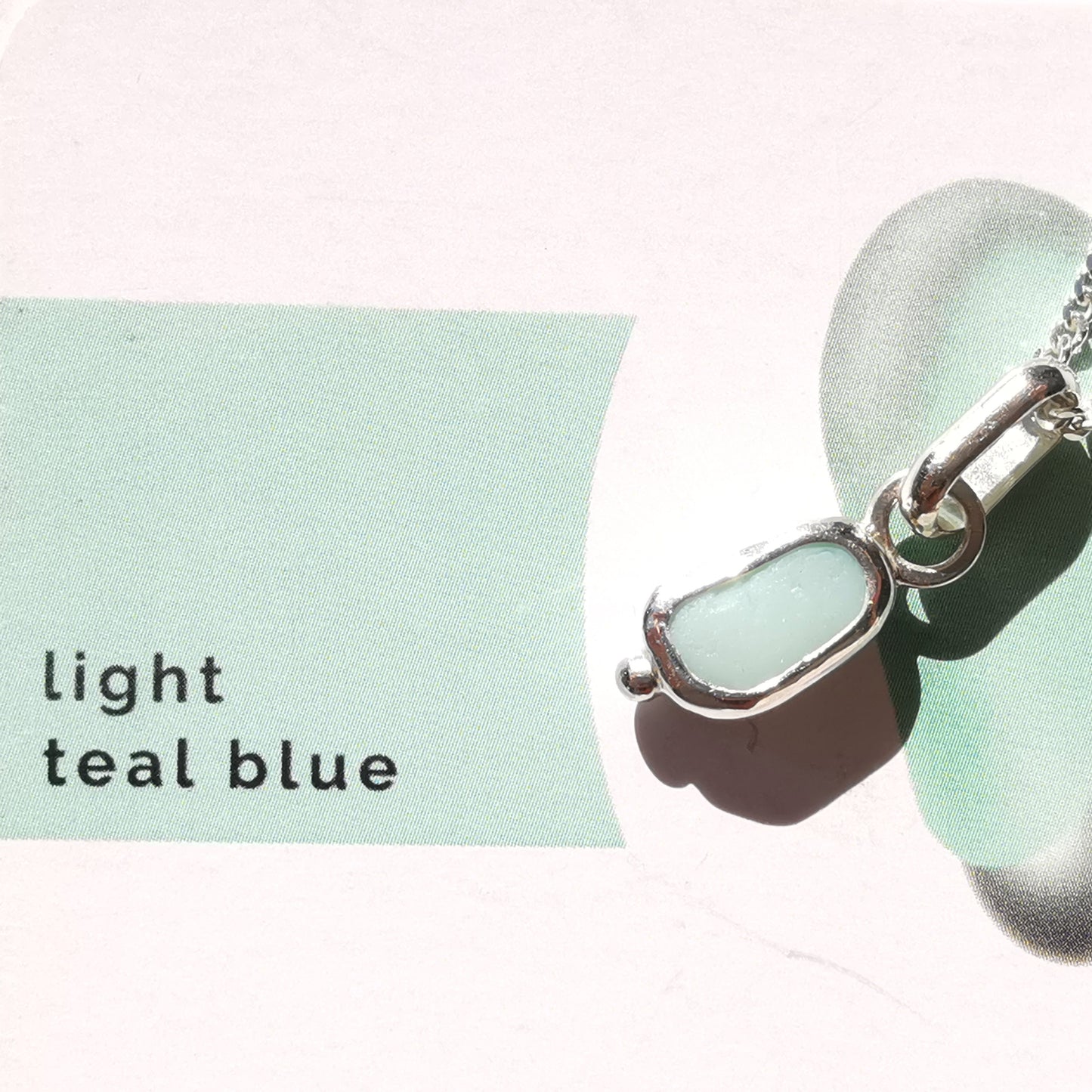 Tiny Scottish UV milk sea glass & sterling silver pendant.