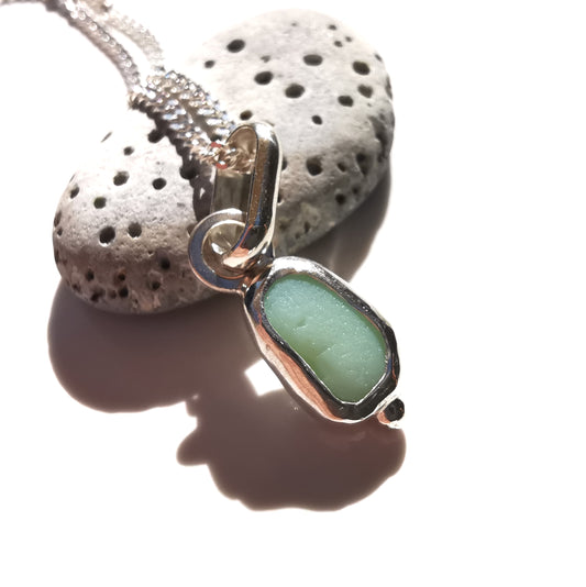 Tiny Scottish UV milk sea glass & sterling silver pendant.