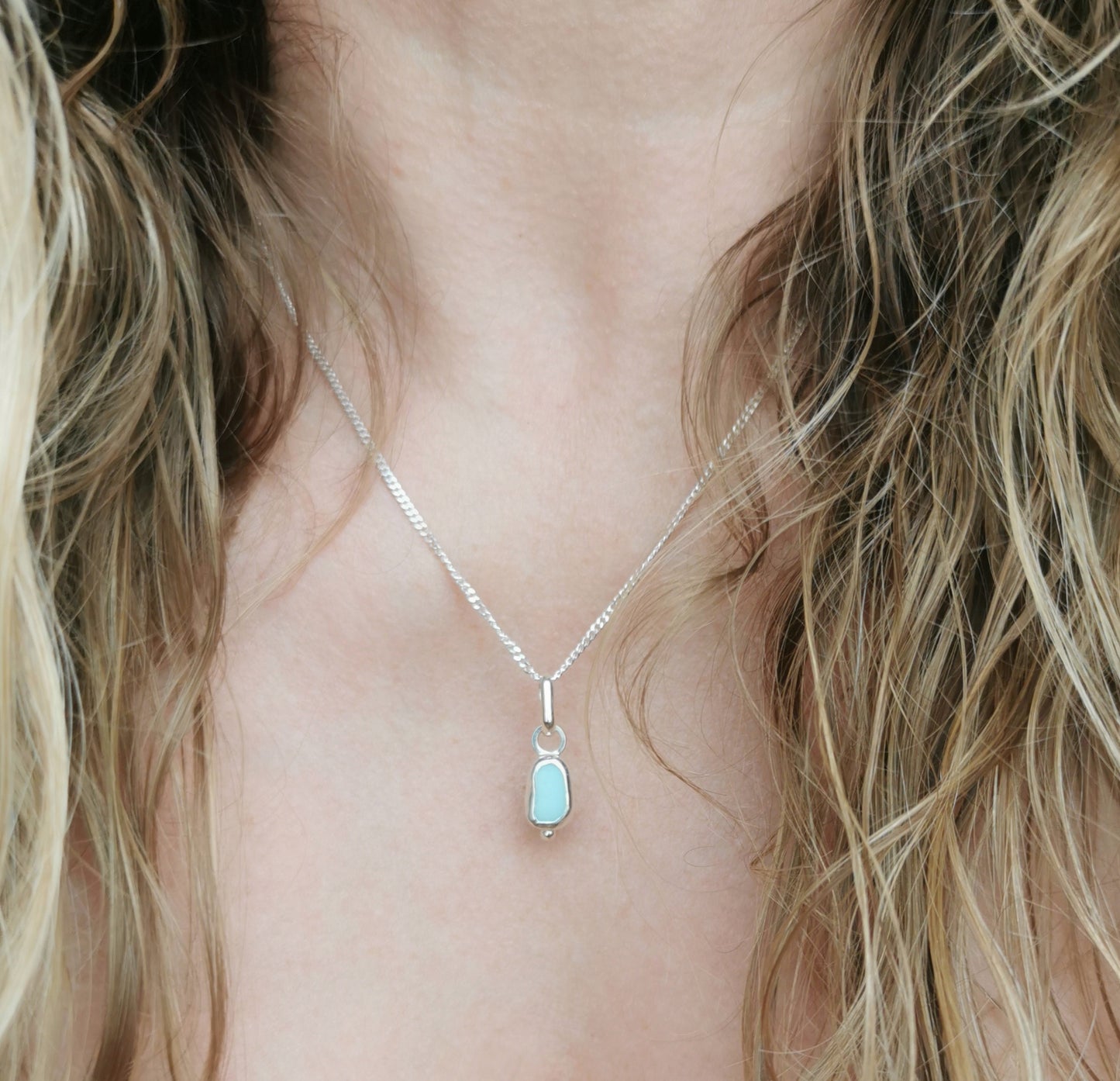Tiny Scottish UV milk sea glass & sterling silver pendant.