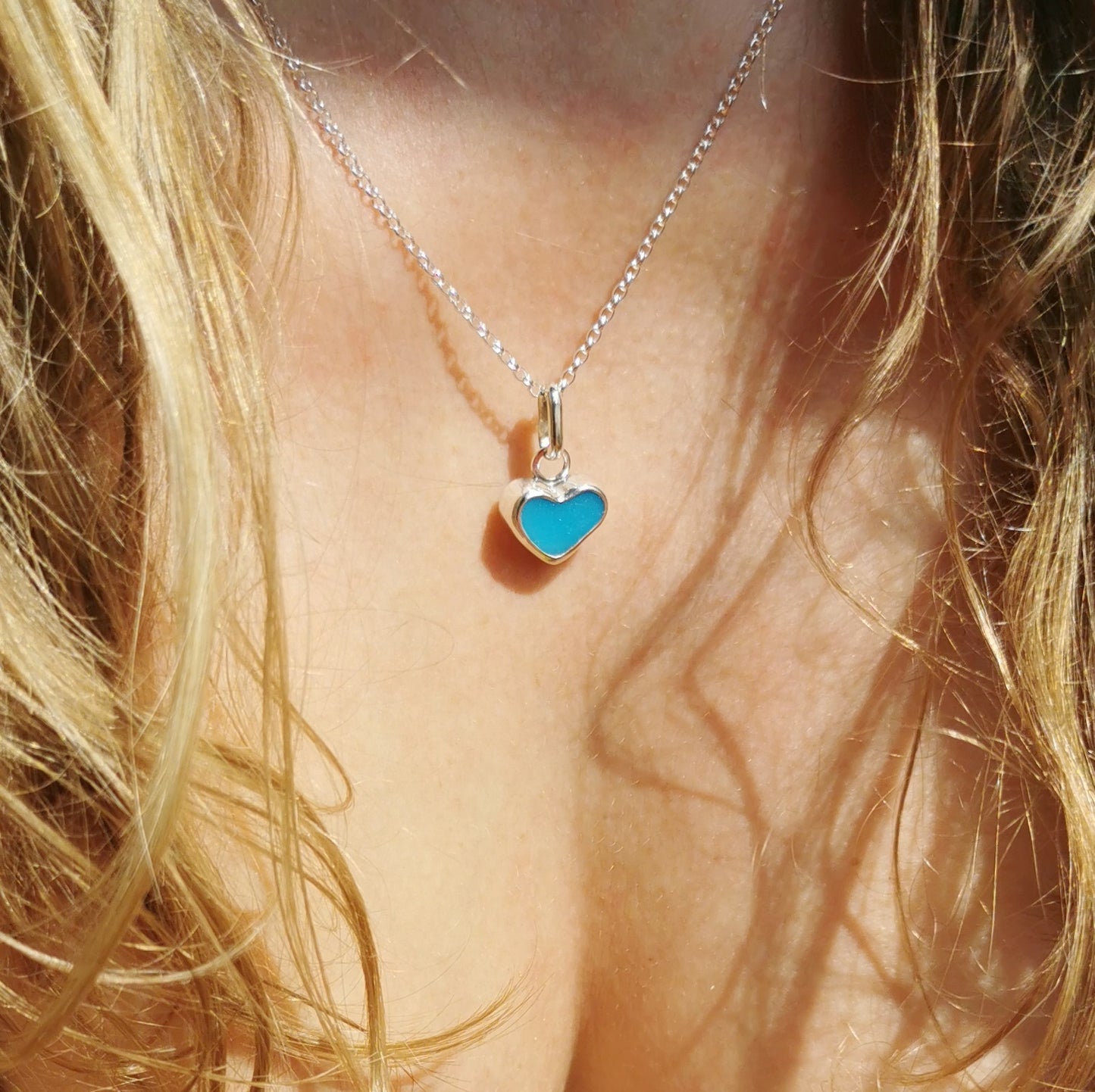 Aquamarine blue sea glass heart & sterling silver pendant.