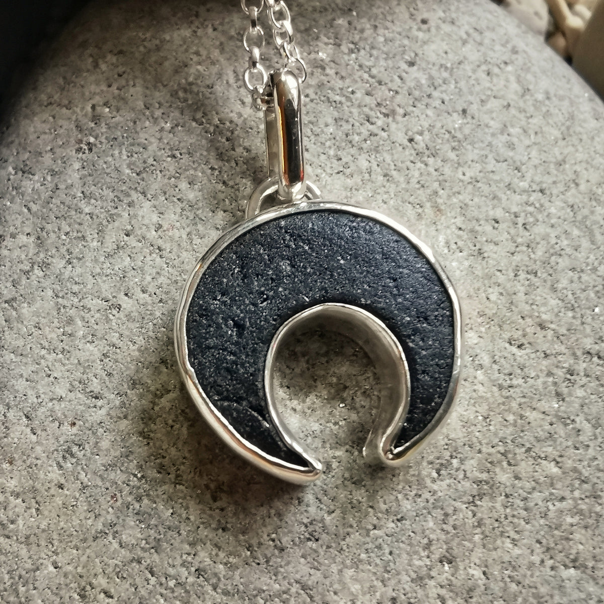 Scottish black sea glass inverted crescent & sterling silver pendant.