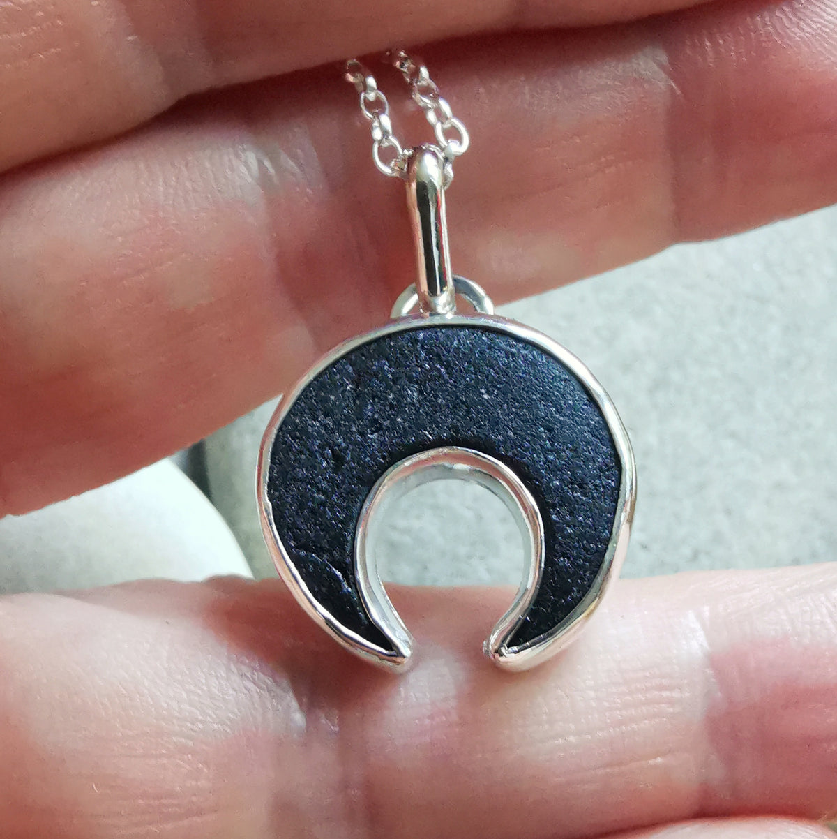 Scottish black sea glass inverted crescent & sterling silver pendant.