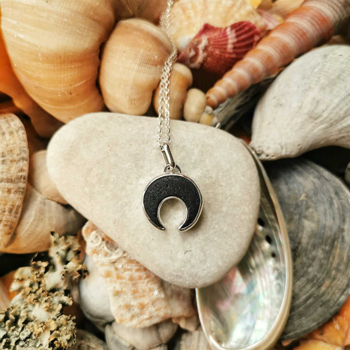Scottish black sea glass inverted crescent & sterling silver pendant.