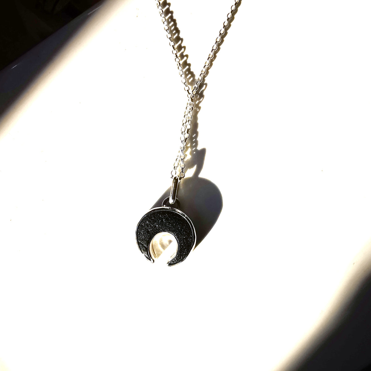 Scottish black sea glass inverted crescent & sterling silver pendant.