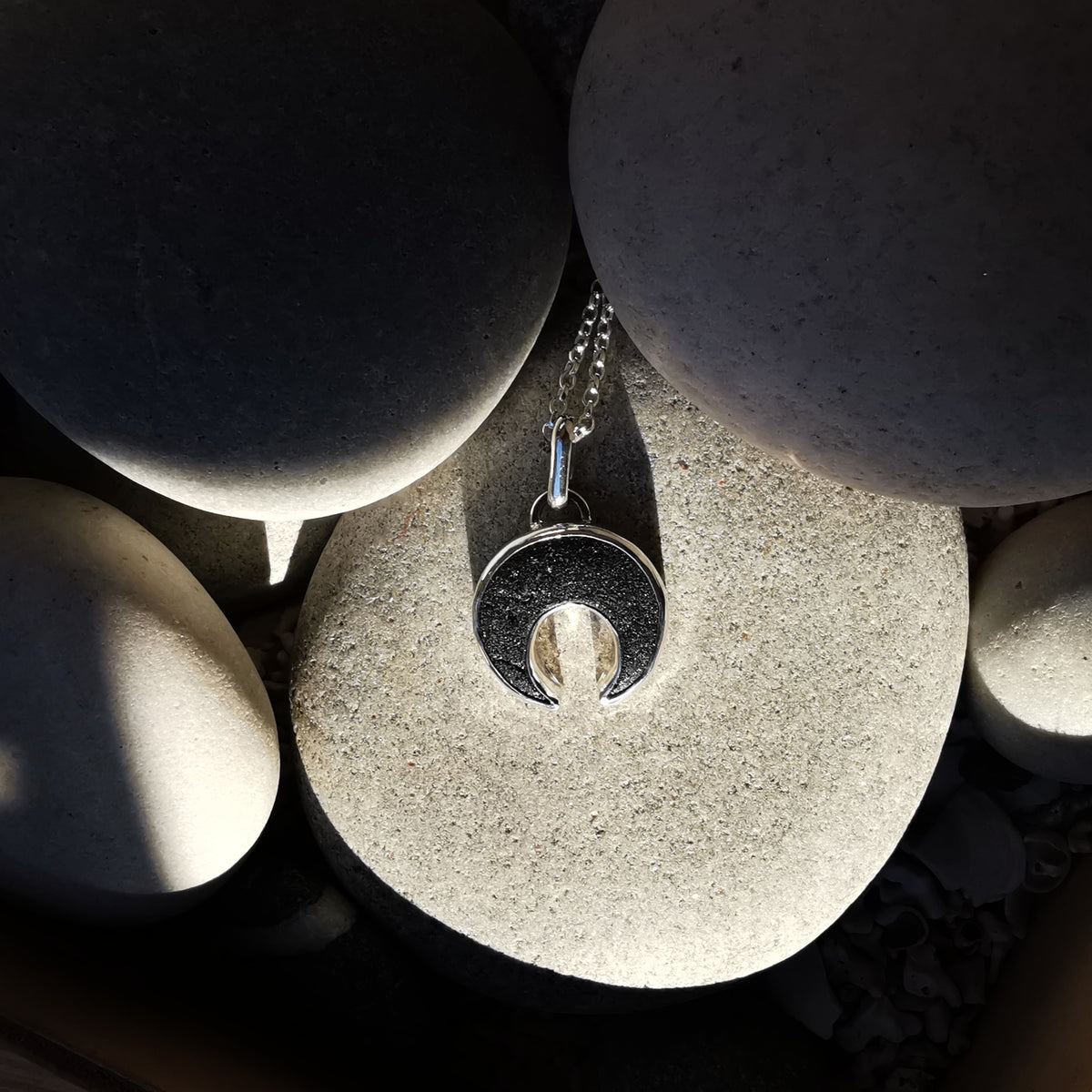 Scottish black sea glass inverted crescent & sterling silver pendant.