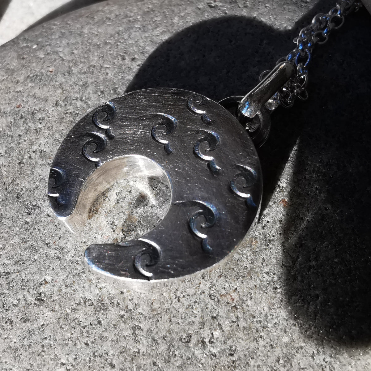 Scottish black sea glass inverted crescent & sterling silver pendant.