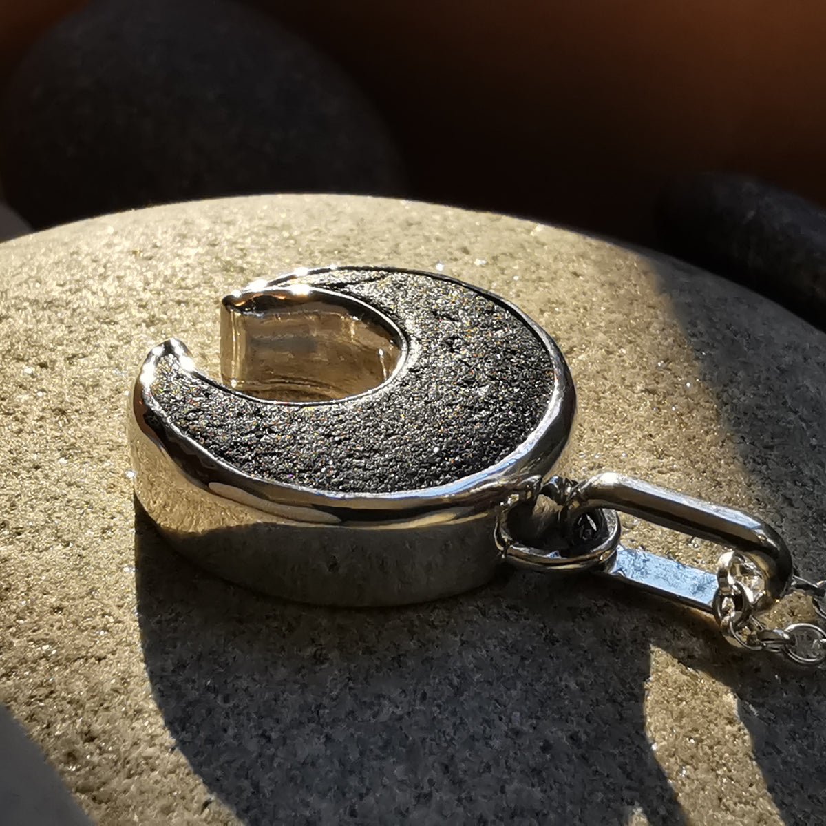 Scottish black sea glass inverted crescent & sterling silver pendant.